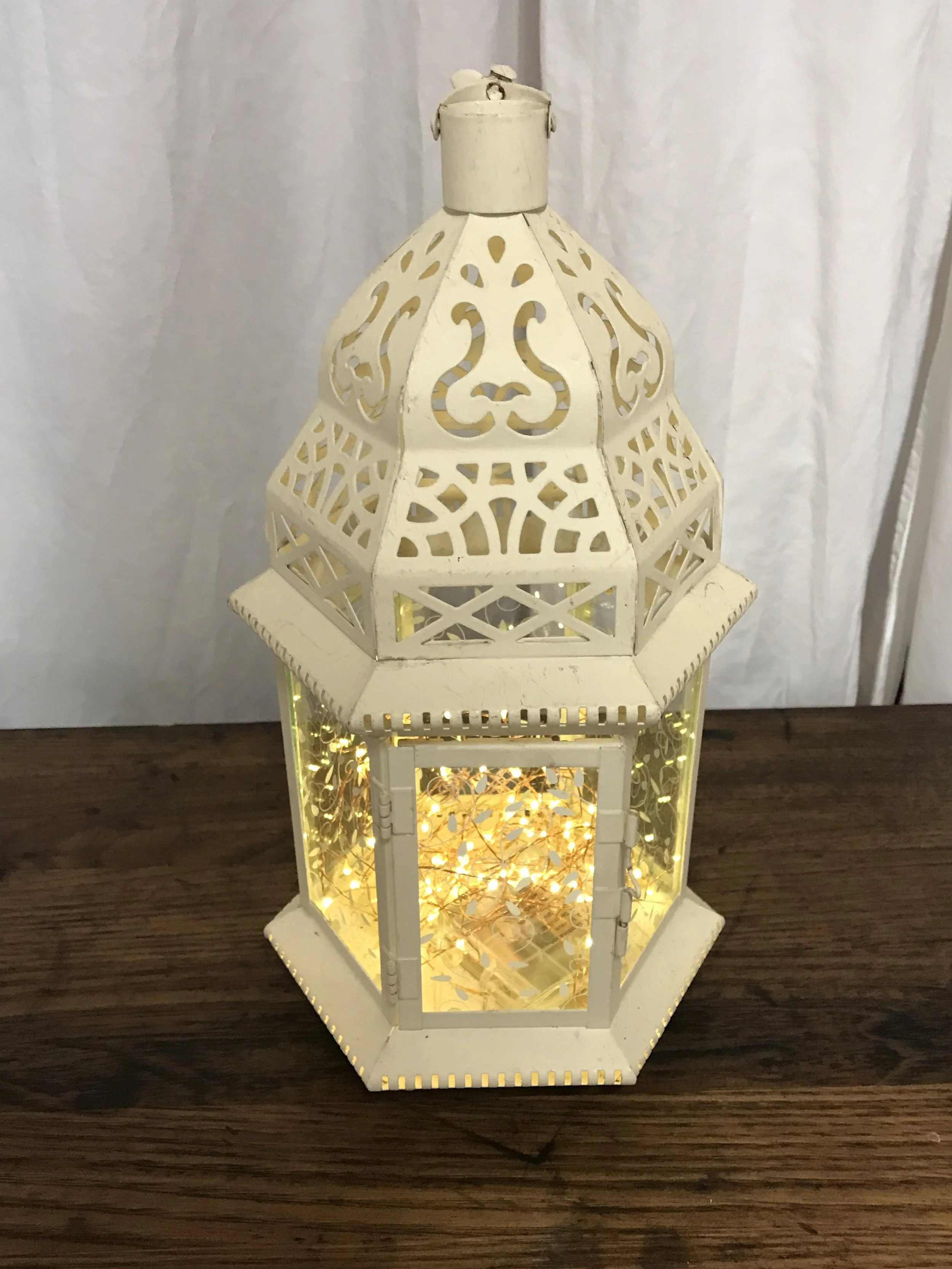 illuminated white bohemian lanterns with remote-controlled fairy lights at an evening event by Berkshire Event Lighting.