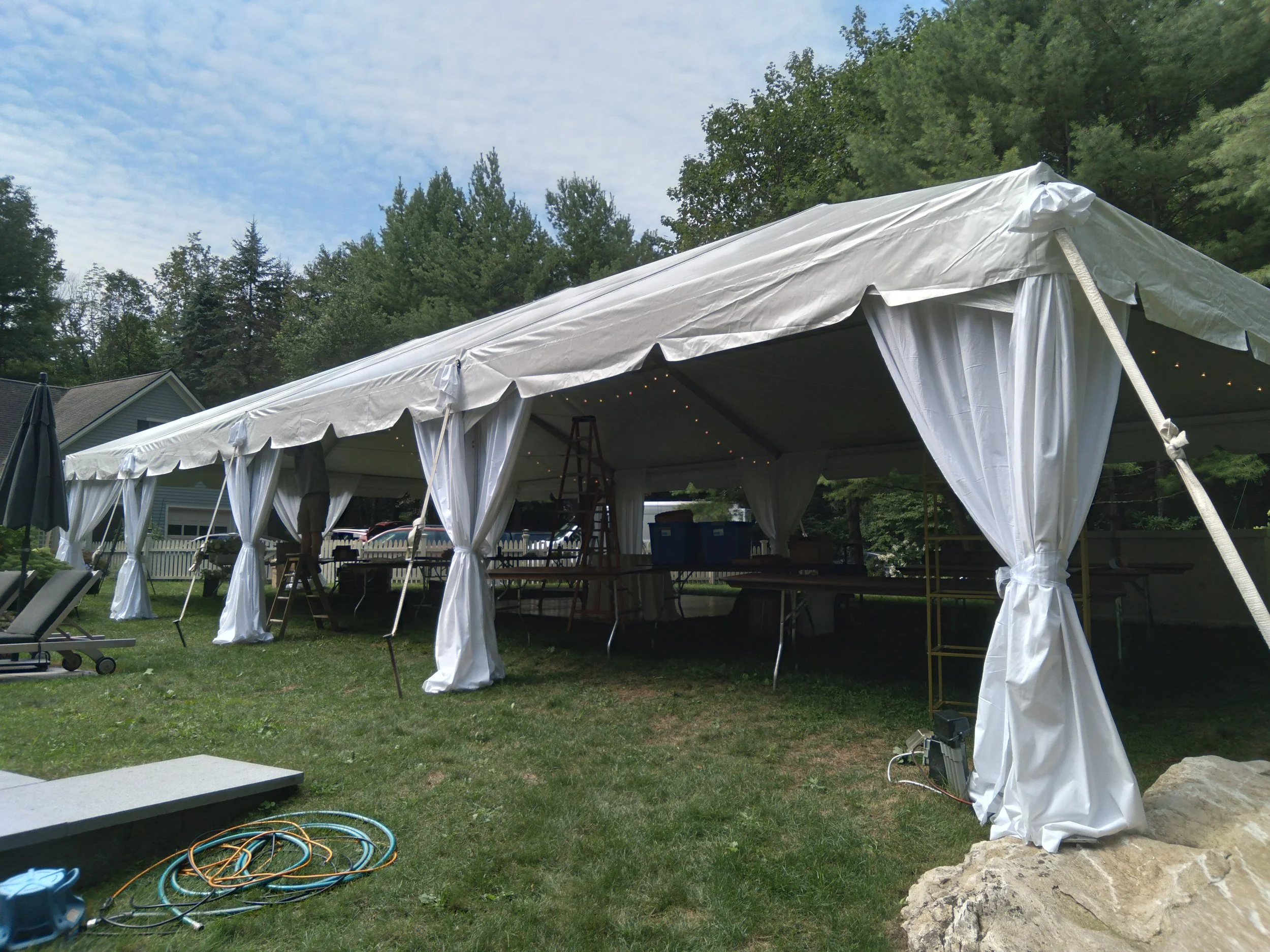 fabric draping on tent perimeter poles for a wedding reception by Berkshire Event Lighting.