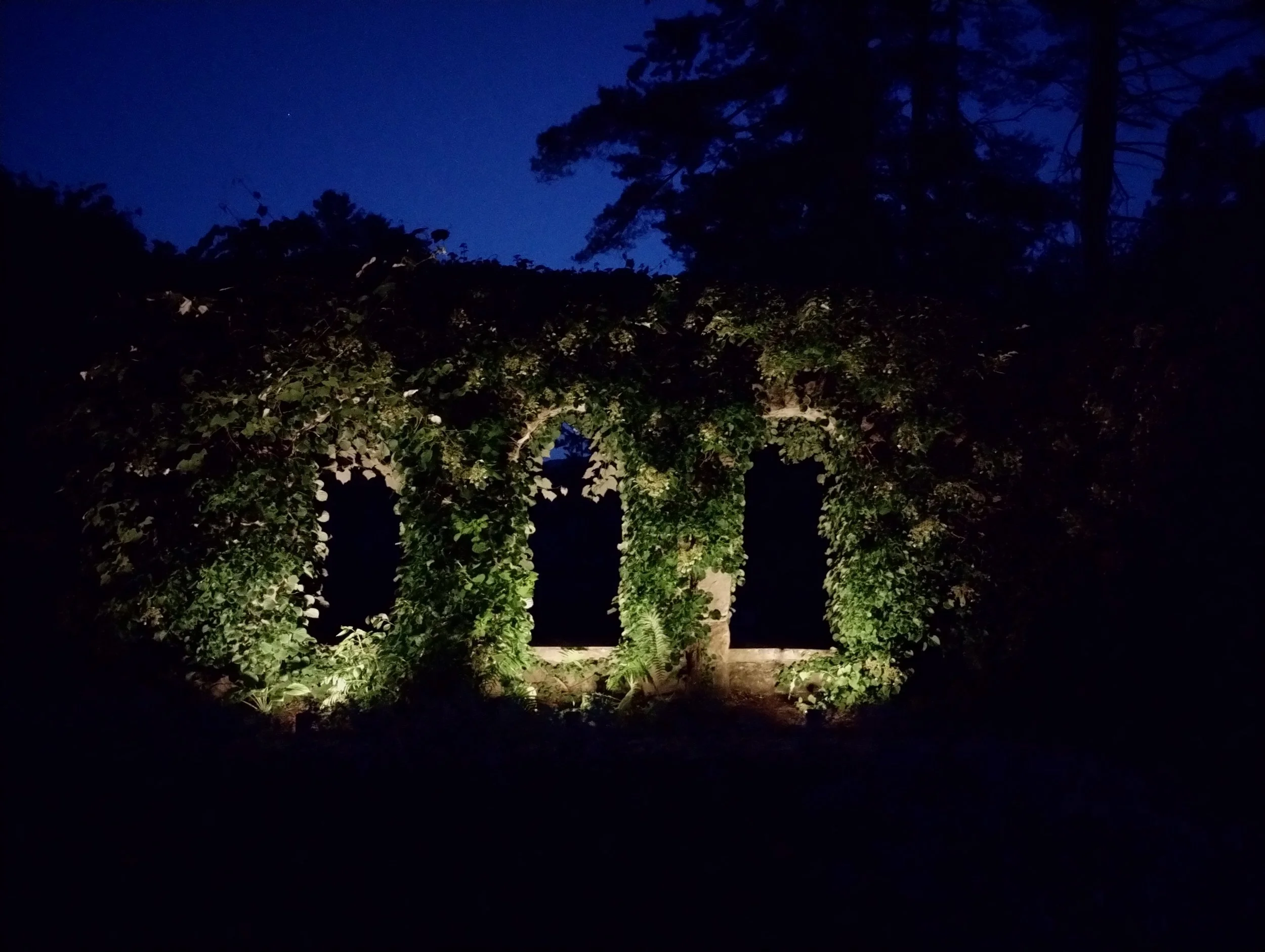 Architectural window uplighting in the Italian Walled Garden at The Mount, Lenox MA, using high-power solar spotlights by Berkshire Event Lighting.