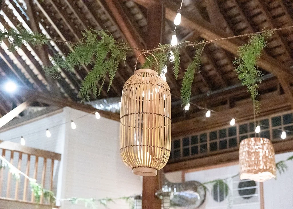 A variety of natural bamboo lanterns in multiple sizes and shapes with battery pillar candles by Berkshire Event Lighting