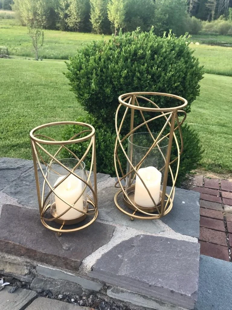 Gold metal spiral lanterns with glass inserts for tabletop wedding decor by Berkshire Event Lighting.