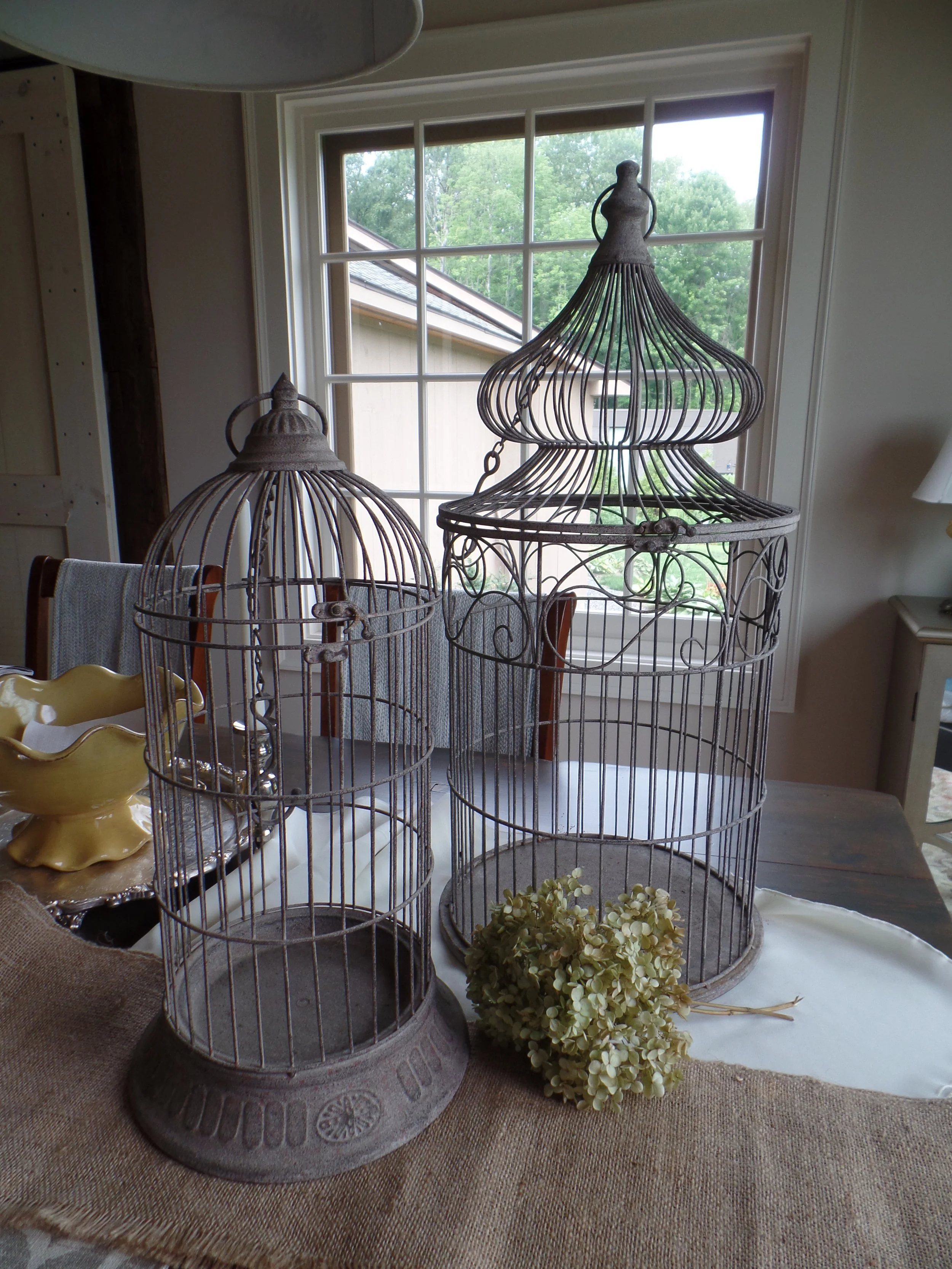 Ornate vintage metal birdcage used as a wedding card holder on a gift table by Berkshire Event Lighting.