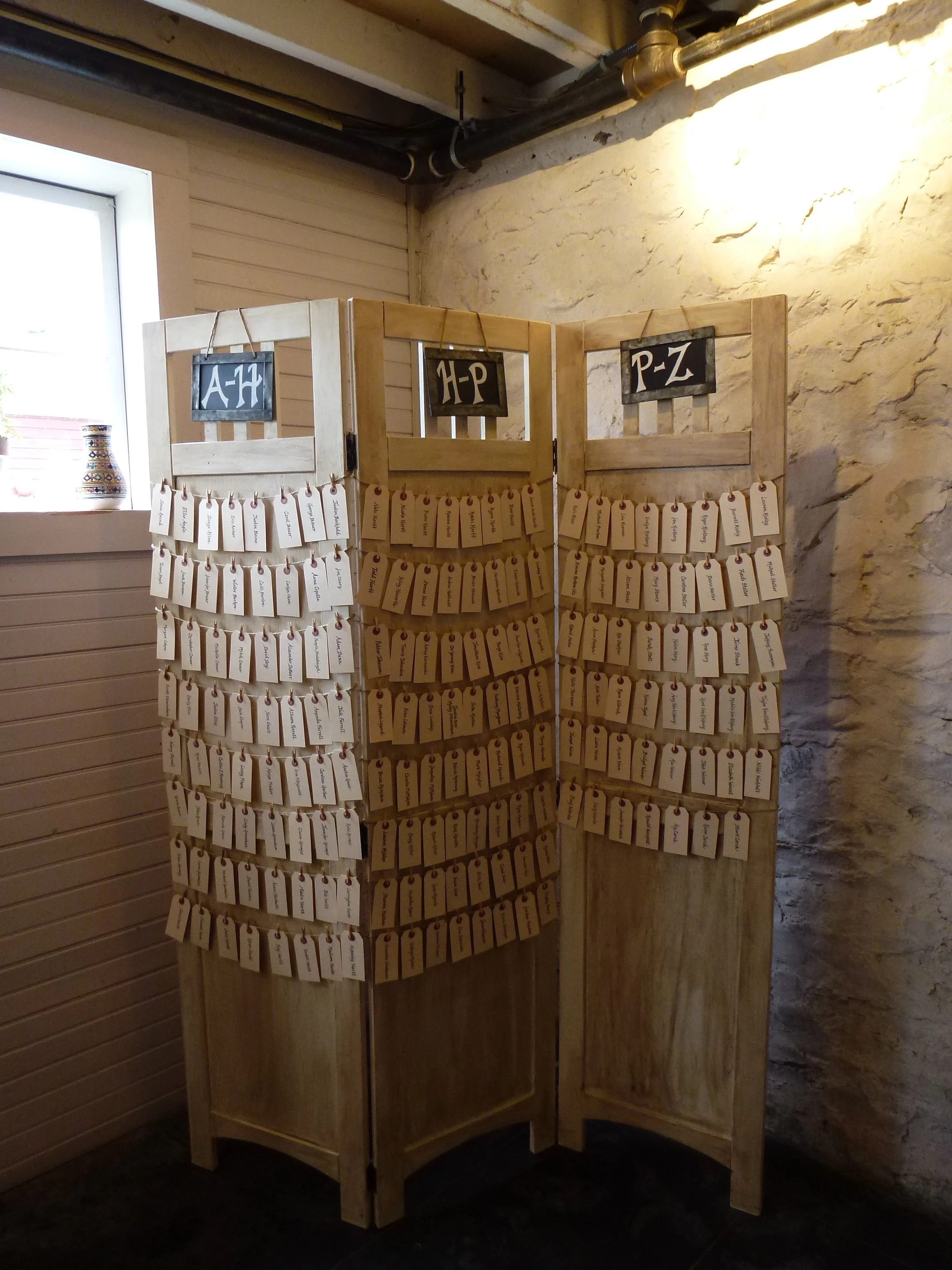 White-washed wooden folding screen for wedding seating charts and decorative room dividers by Berkshire Event Lighting.