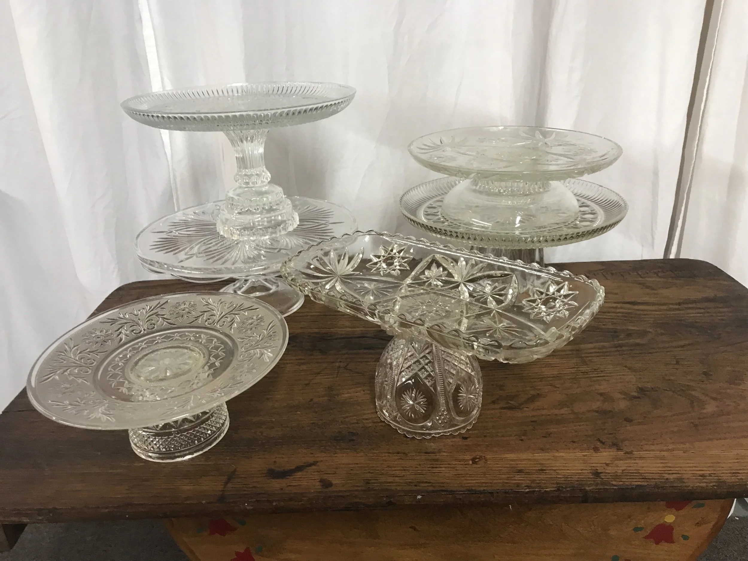Assorted vintage cut glass cake and dessert stands in various heights for wedding dessert tables by Berkshire Event Lighting.