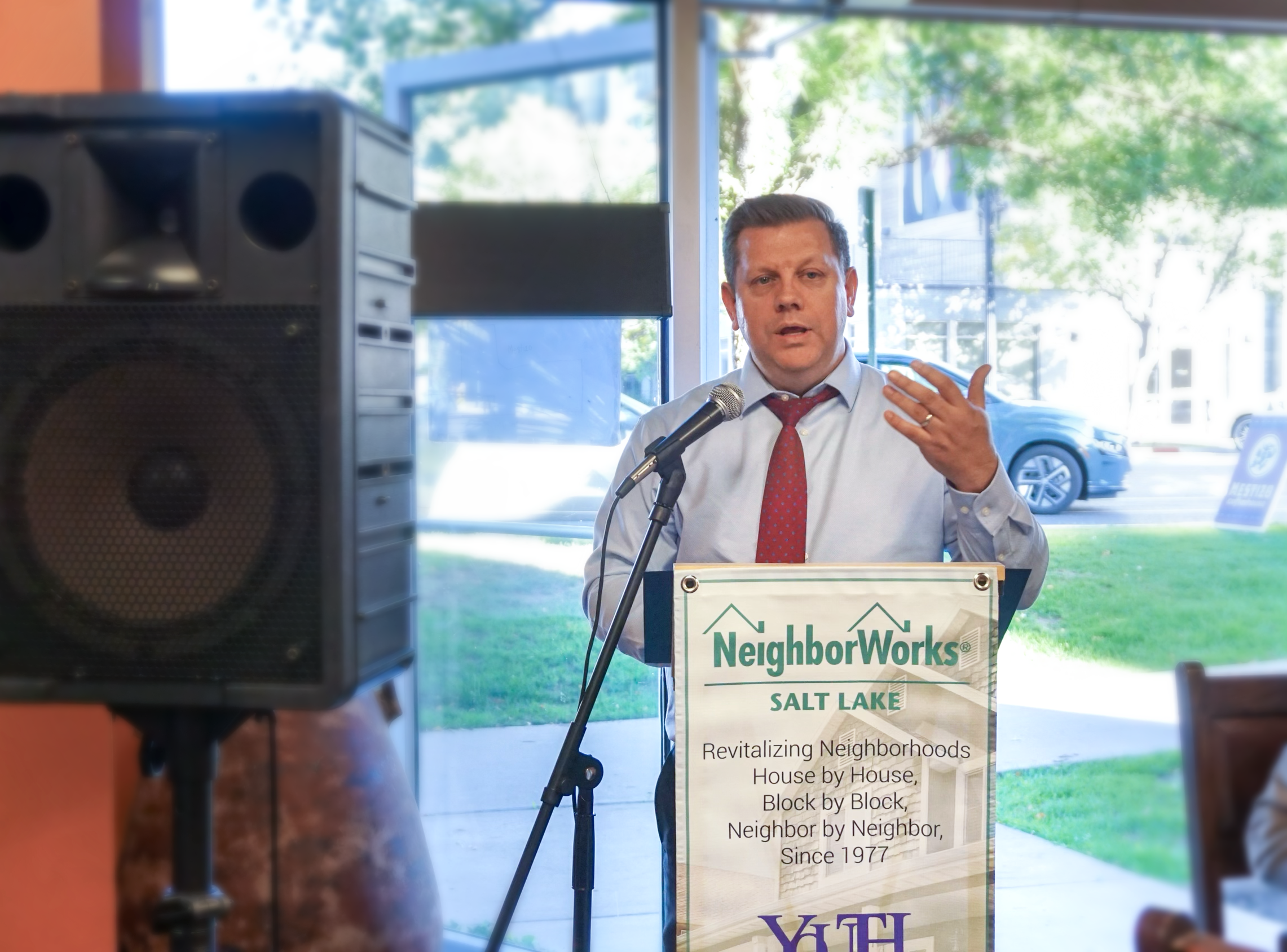 A representative of the Larry H. & Gail Miller Family Foundation announces the launch of the Westside Community Grant at Mestizo Coffeehouse in Salt Lake City on October 9, 2024.