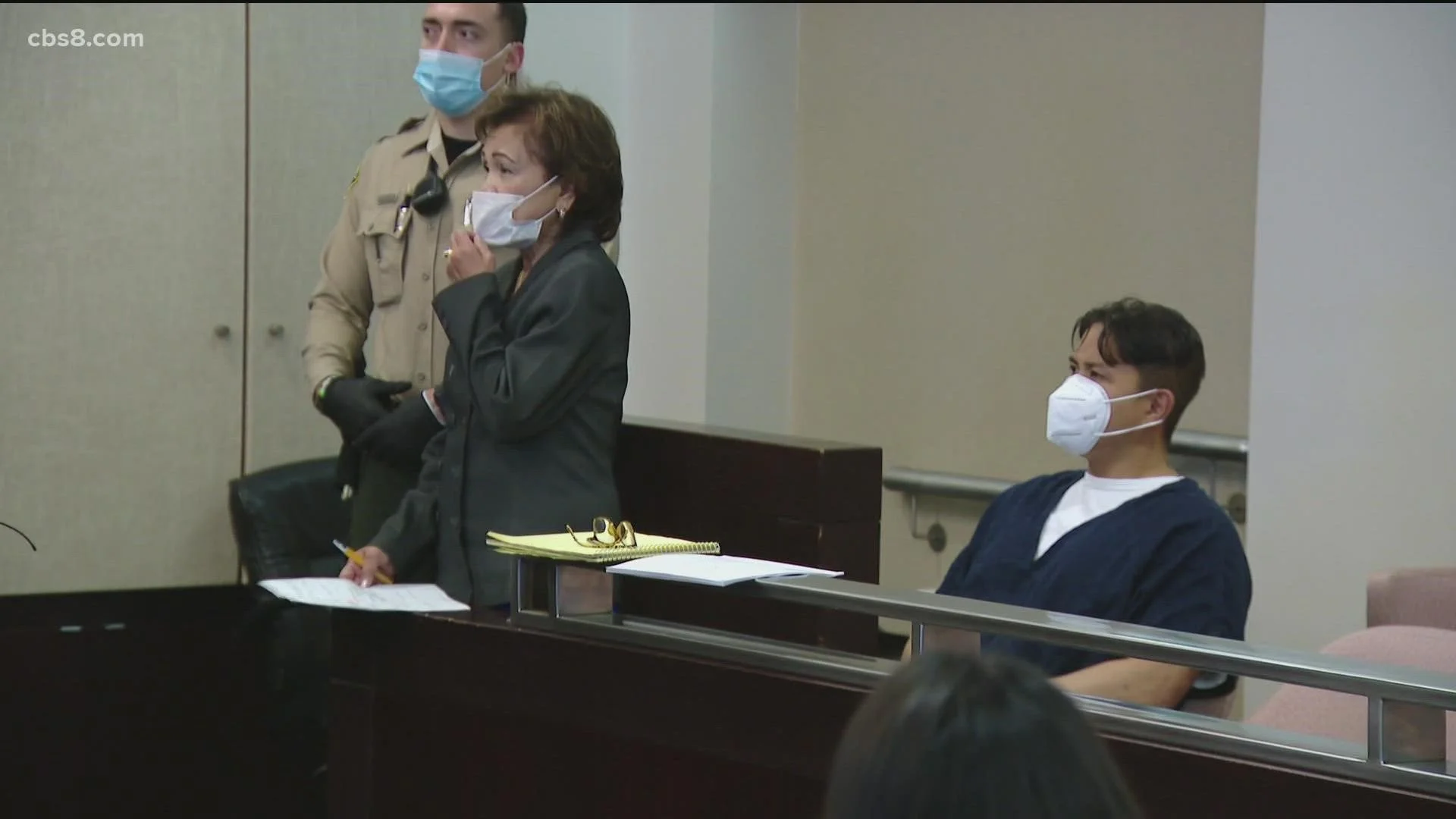 man and his attorney in court wearing masks