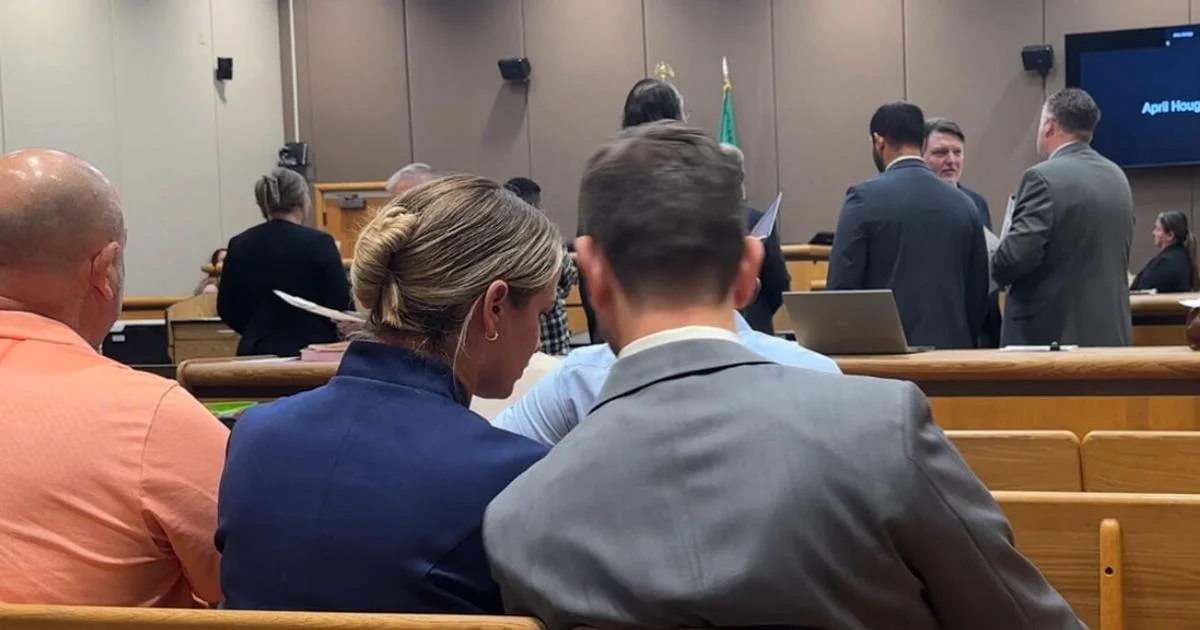 Picture of woman and her attorney from behind, court in session