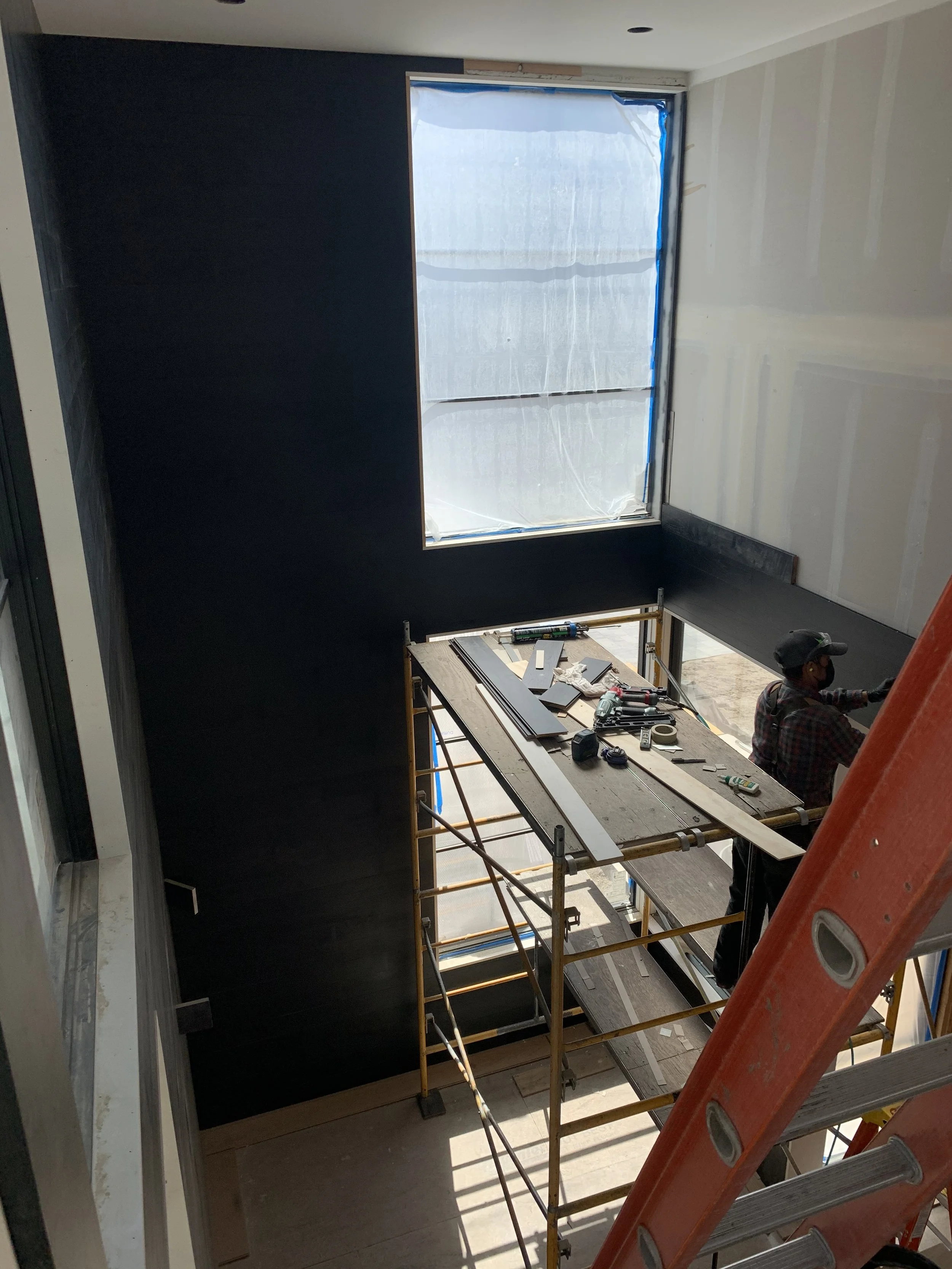 Instead of just painting the walls black, I added wood all the way to the ceiling to add depth and texture.