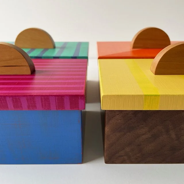 A Valerie Berlage mirror piece with multicolored blocks of wood surrounding a circular mirror.