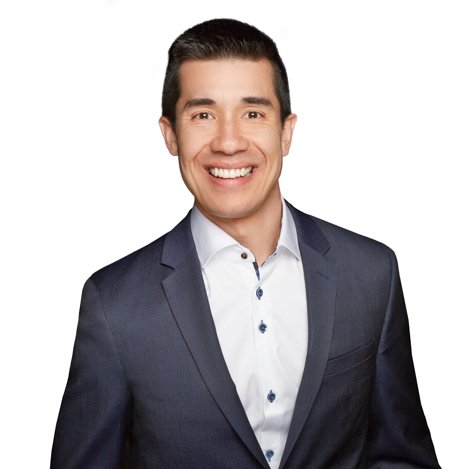 Professional portrait of a smiling man with short dark hair, wearing a dark suit jacket over a white dress shirt, against a white background.