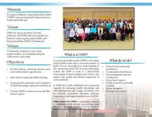 A group photo showing a diverse crowd of people gathered in an indoor setting, possibly a community or organizational event. There are multiple rows of individuals, some standing and others seated, facing the camera.