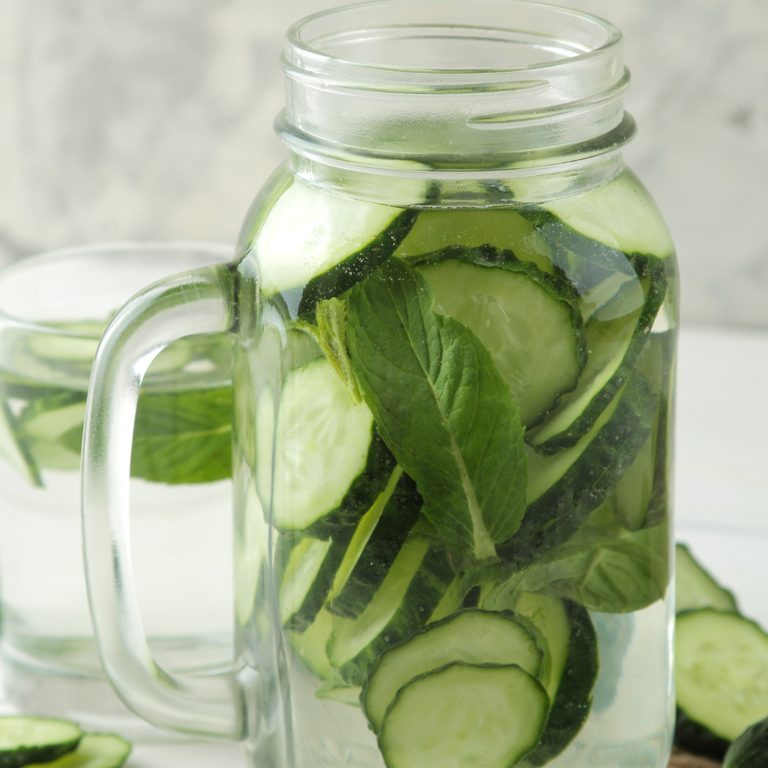 Glass of room-temperature cucumber mint water, Ayurvedic Pitta cooling drink