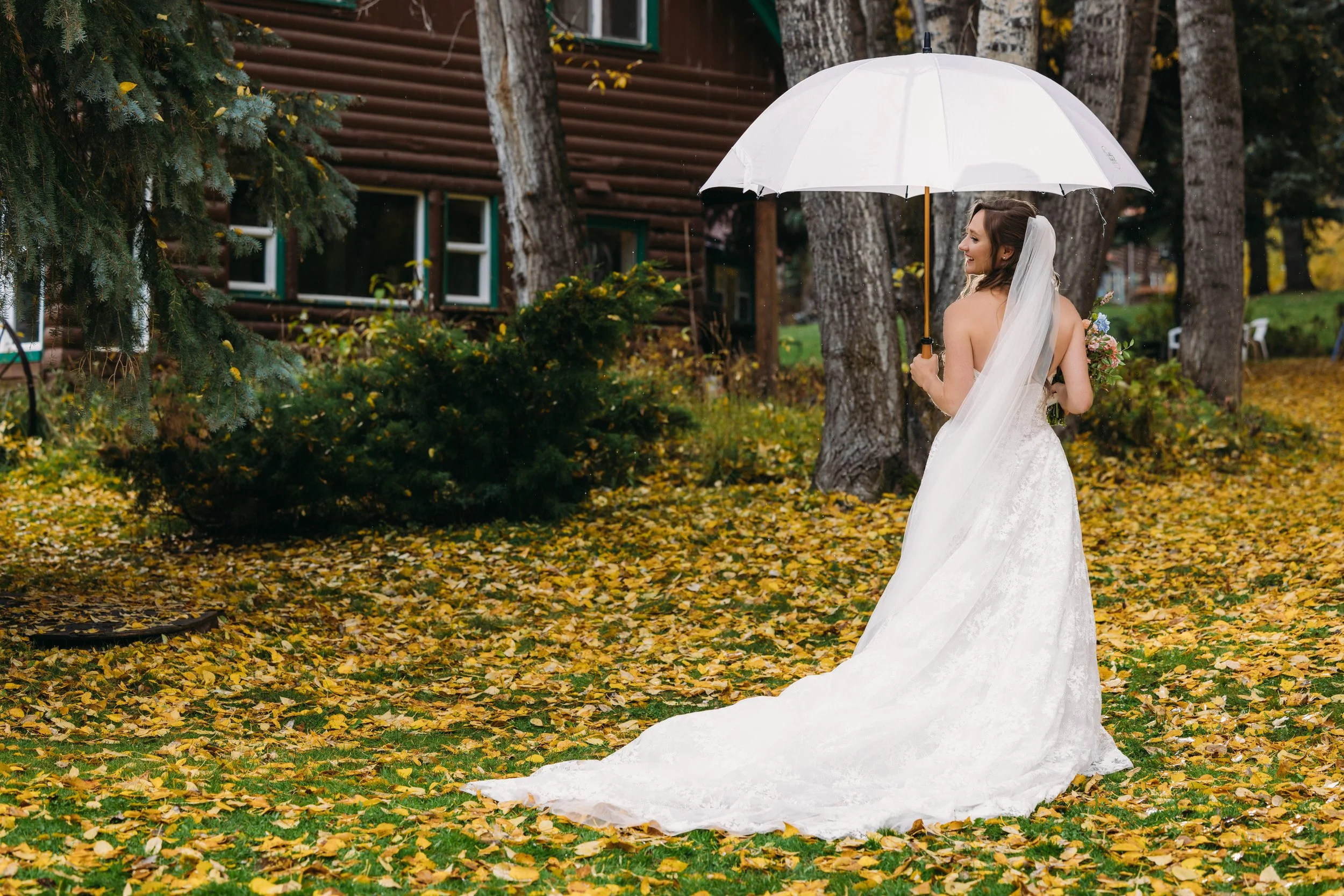 A beautiful Snowmass, Colorado bride wearing a romantic half-up bridal hairstyle with seamless hair extensions. Soft waves and added volume created an elegant, timeless look perfect for her mountain wedding, showcasing luxury bridal hair styling in A