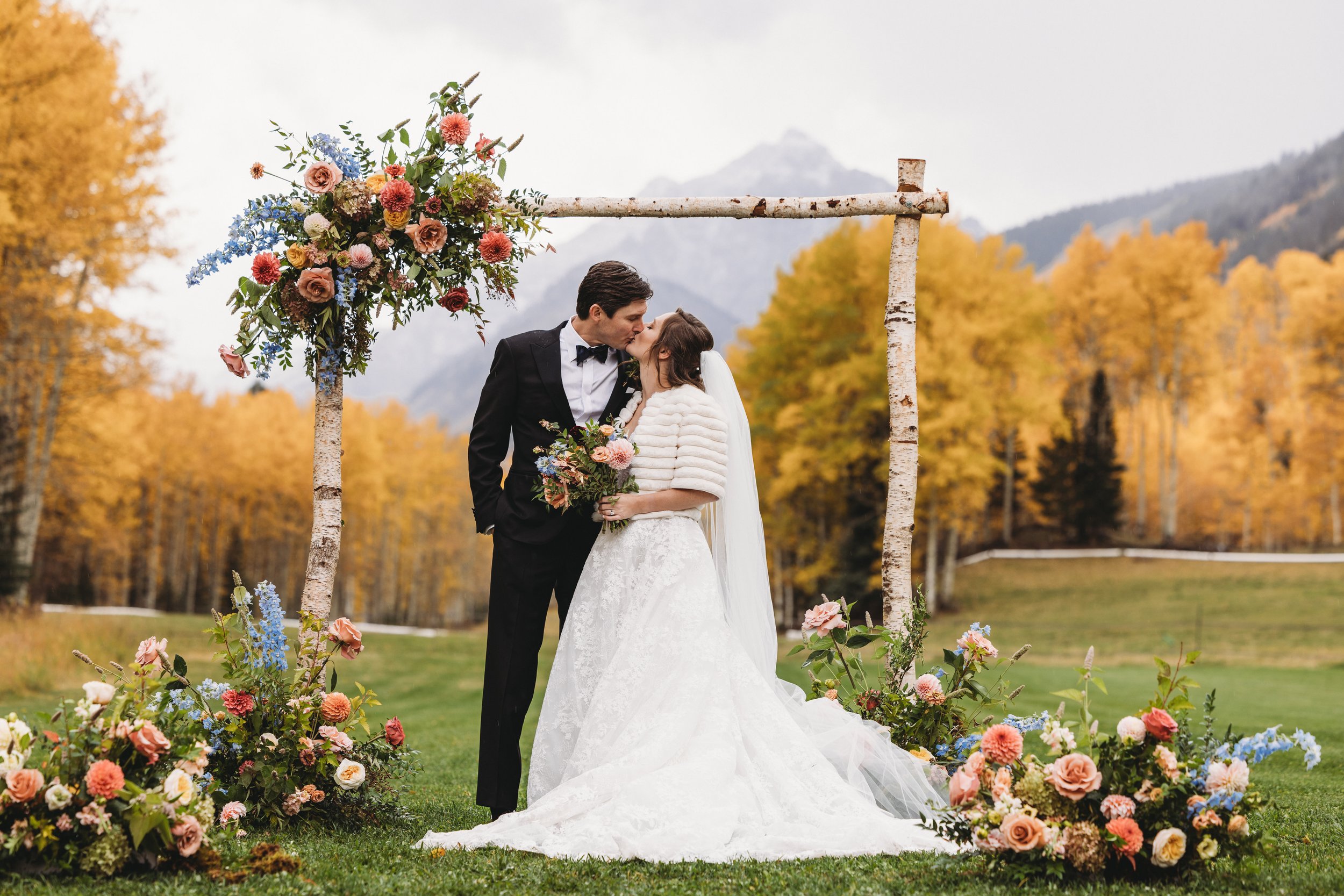 A beautiful Snowmass, Colorado bride wearing a romantic half-up bridal hairstyle with seamless hair extensions. Soft waves and added volume created an elegant, timeless look perfect for her mountain wedding, showcasing luxury bridal hair styling in A