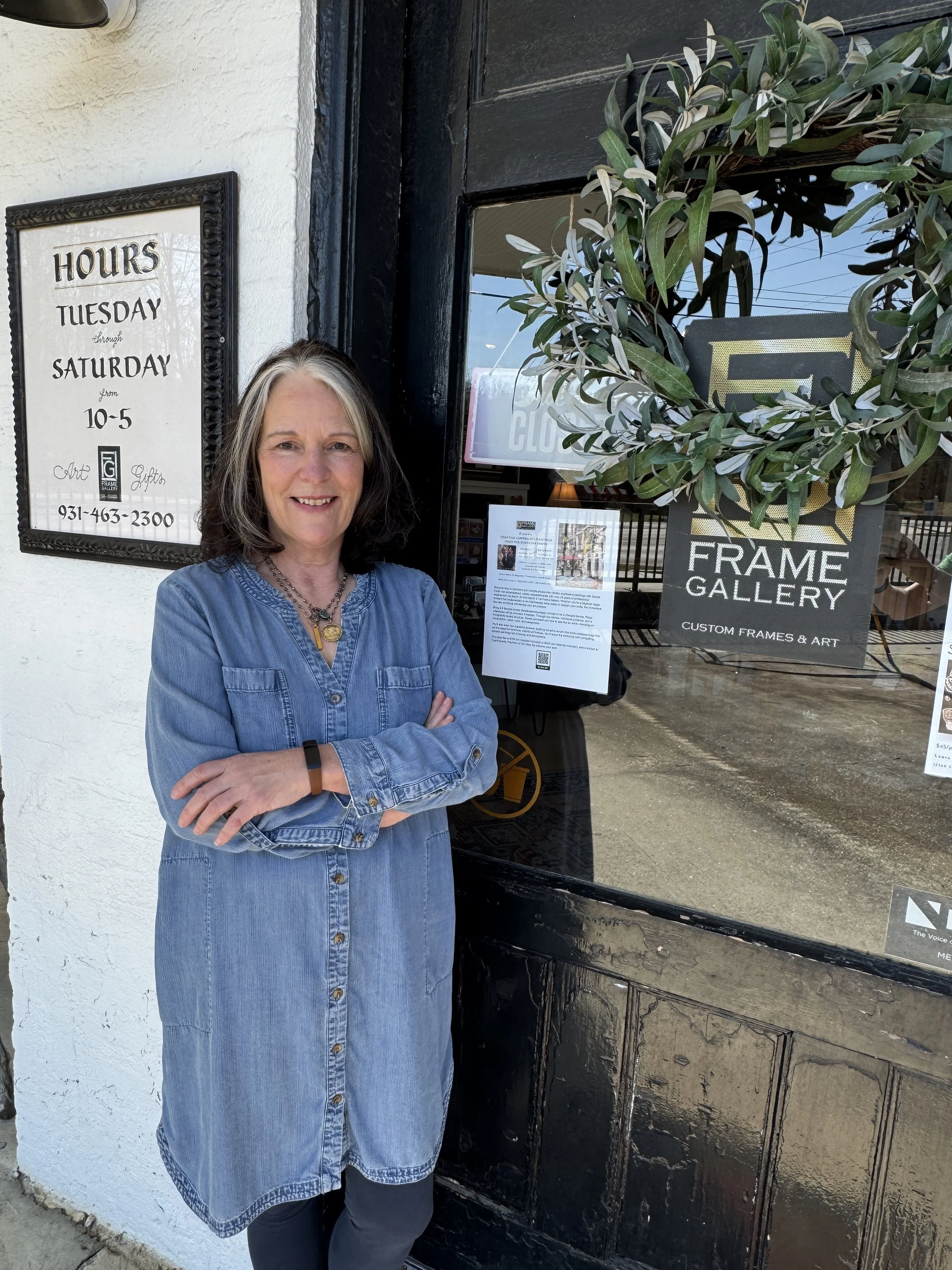 Harriet Runkle standing at the front door of Frame Gallery