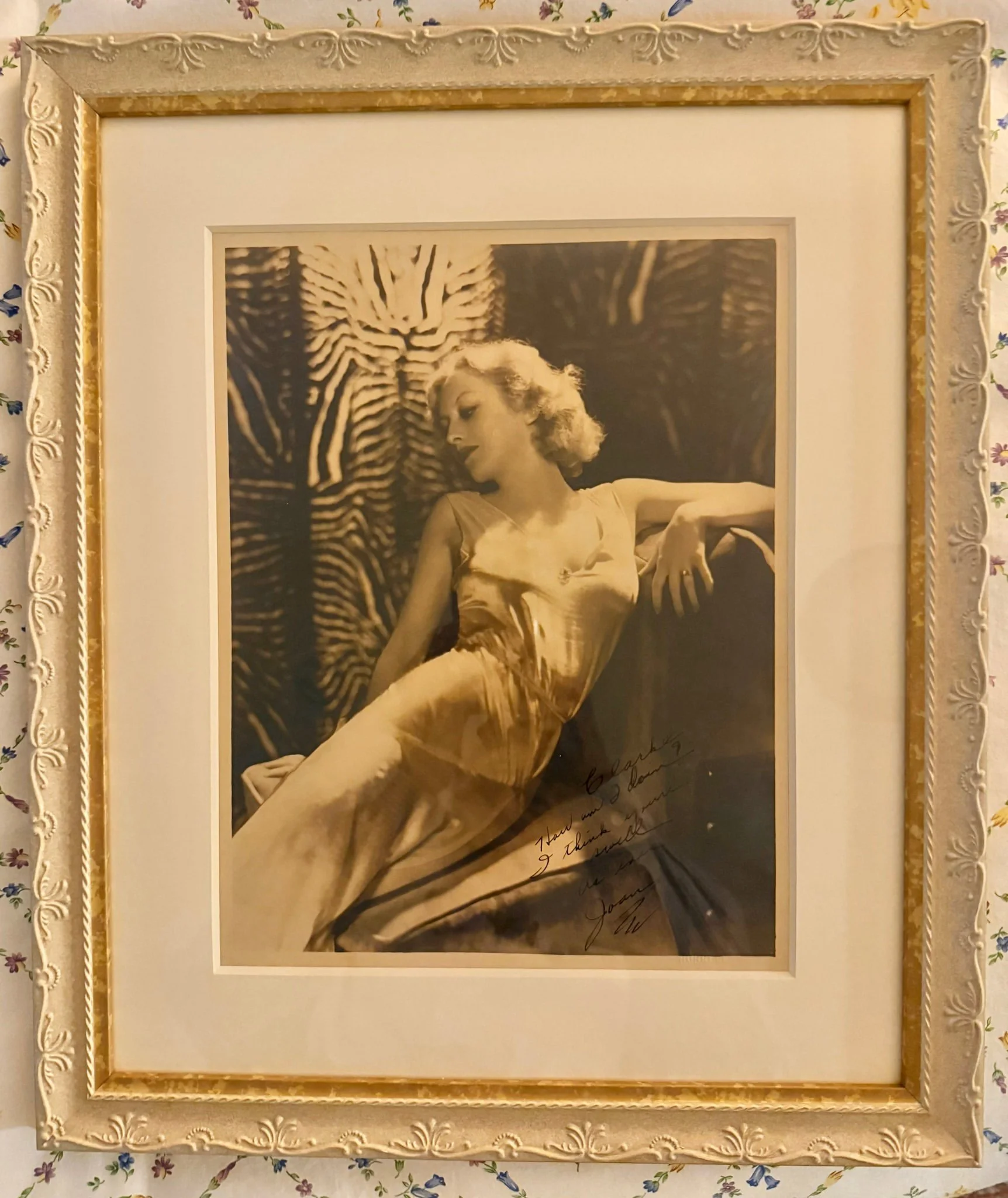 This Friday's favorite framing project is an autographed photograph of Joan Crawford inscribed to Clark Gable. The warm matting complements Joan's beautiful, flawless complexion, while the subtle floral pattern of the ivory frame hints at her eleganc