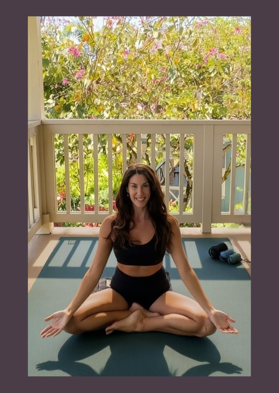Woman sitting in a meditative yoga pose in nature looking vibrant, joyful, wise, embodied, clear, and ready to help you feel more alive and empowered by having a meaningful, supportive conversation.