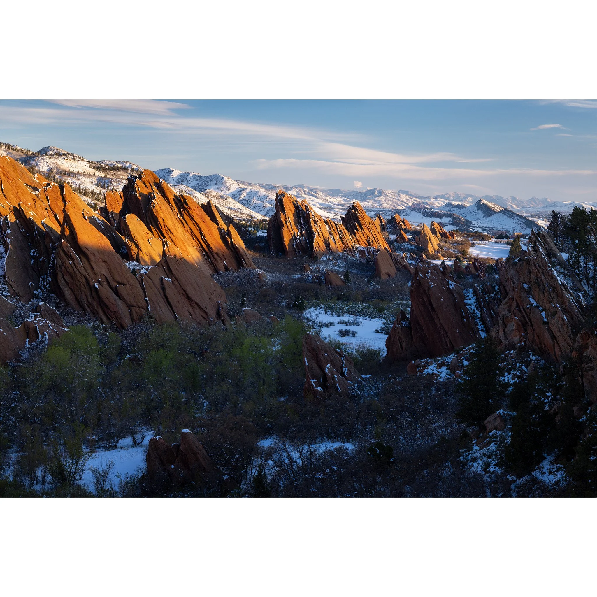 Morning light on red sandstone fins with fresh spring snow at Roxborough State Park, Douglas County, Colorado.