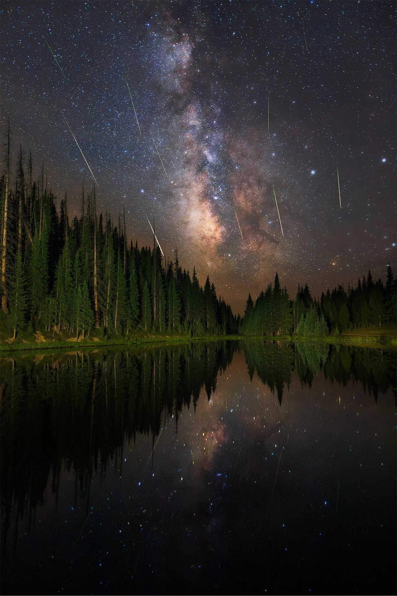 Perseid meteors and the Milky Way reflected in a still alpine lake at night, Rocky Mountain National Park, Colorado.