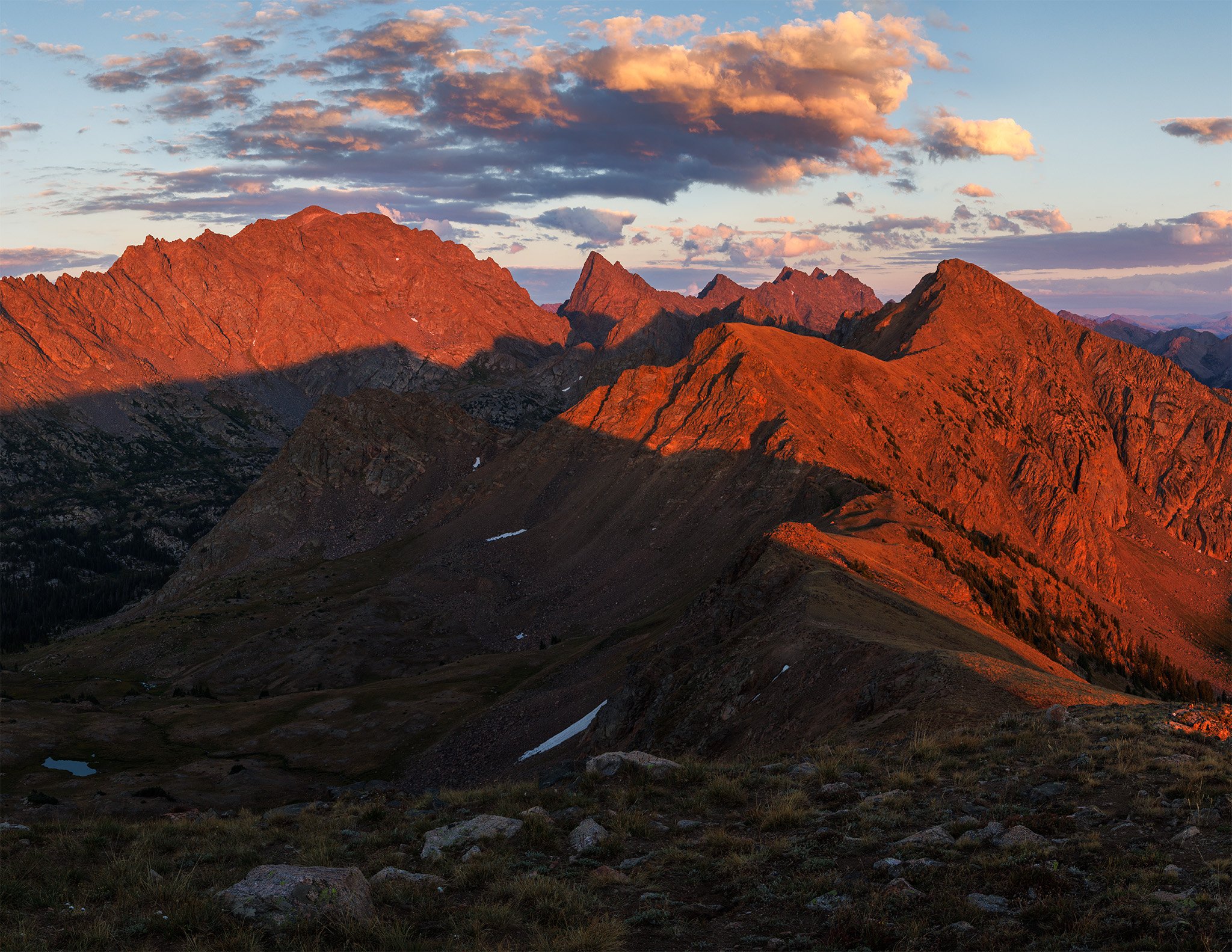 Red wildfire-smoke light on the peaks of the Gore Range at sunset, Eagle County, Colorado.