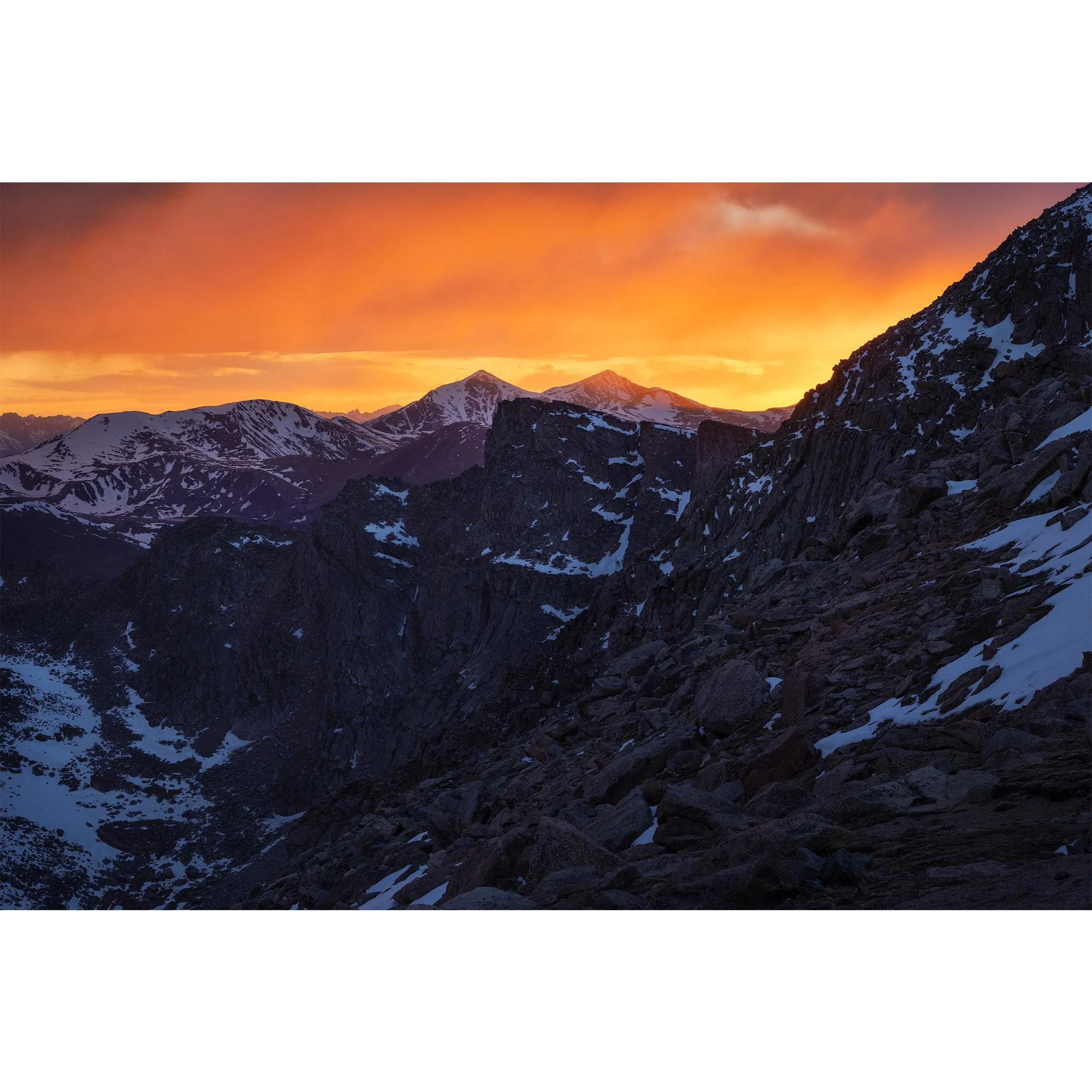 Orange sunset sky over Grays and Torreys Peaks seen from the Mount Blue Sky road, Front Range, Colorado.