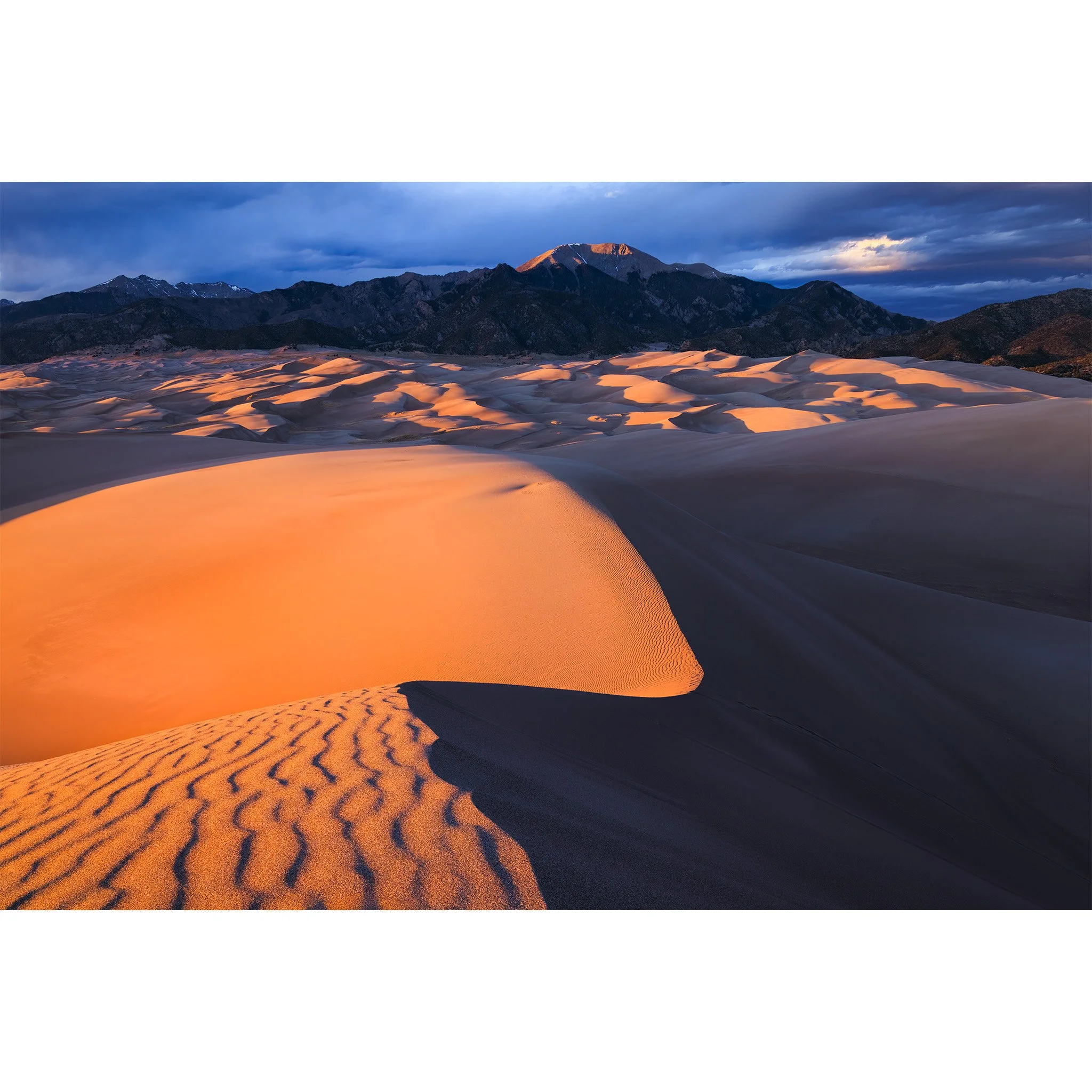 Sunset light on the dunes at Great Sand Dunes National Park with the Sangre de Cristo Mountains behind, Colorado.