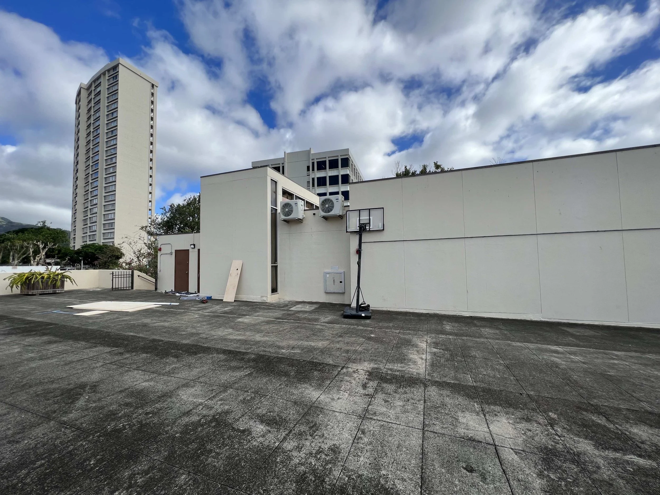 Zoomed out look at two of the four outdoor AC units on the rooftop 