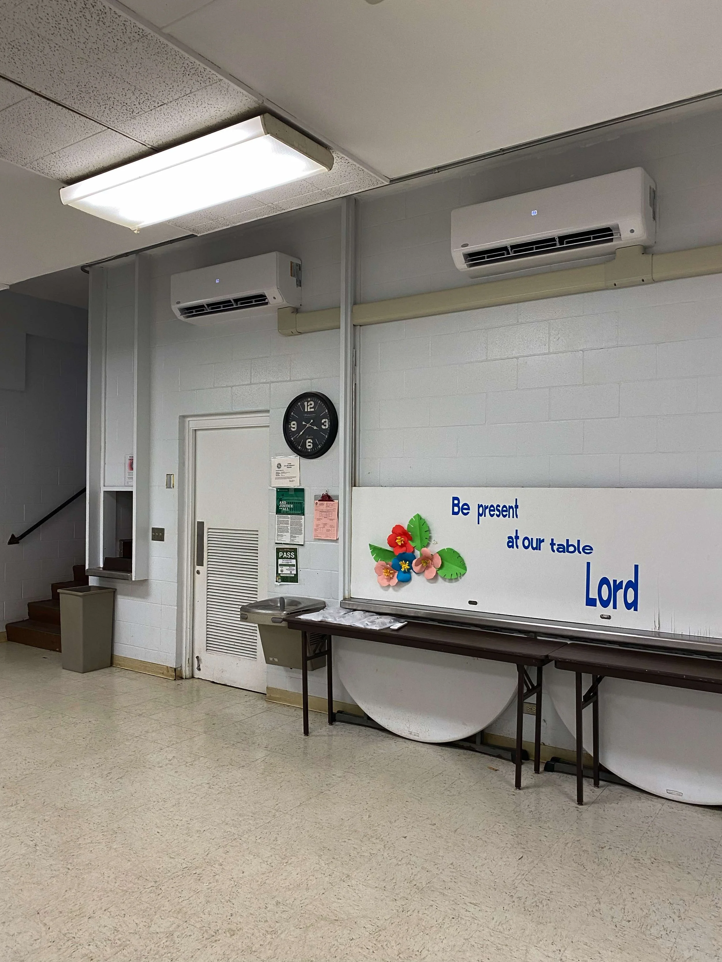 Alternative angle view of two wall-mounted mini-split AC units in a room.