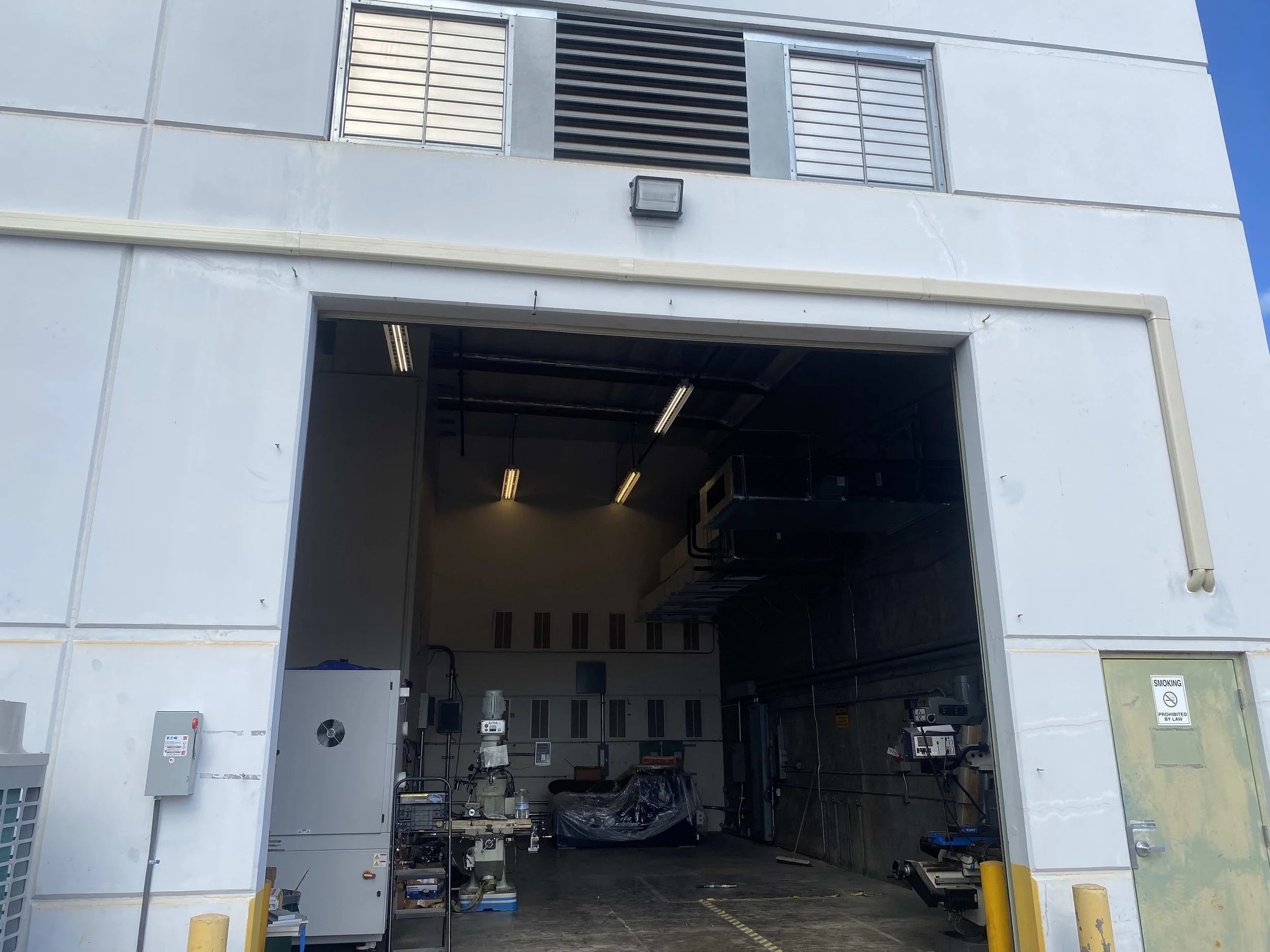 Exterior view above the doorway showing new AC piping installation