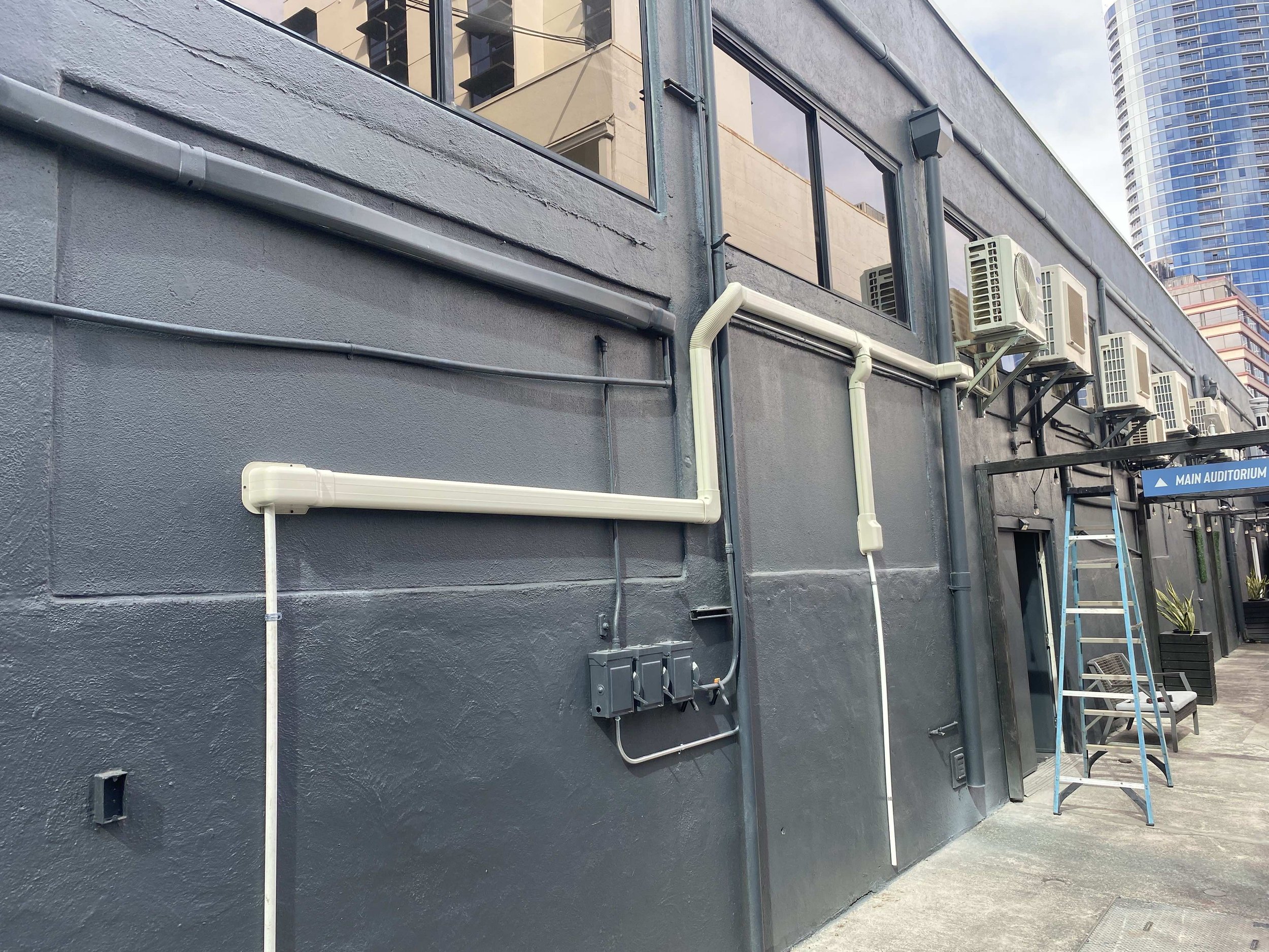 AC piping running along the exterior, wide view