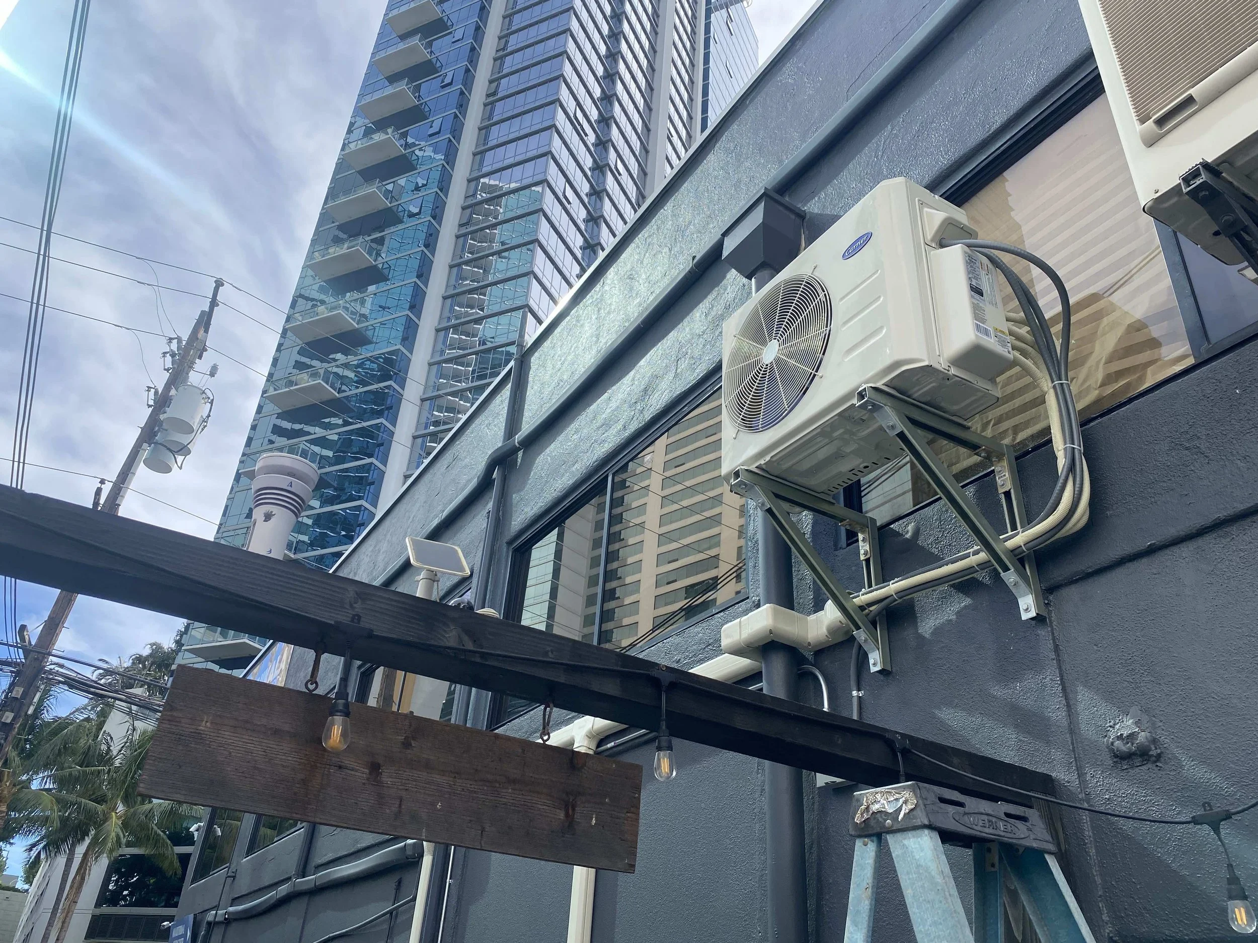 Newly installed AC unit mounted on building's exterior