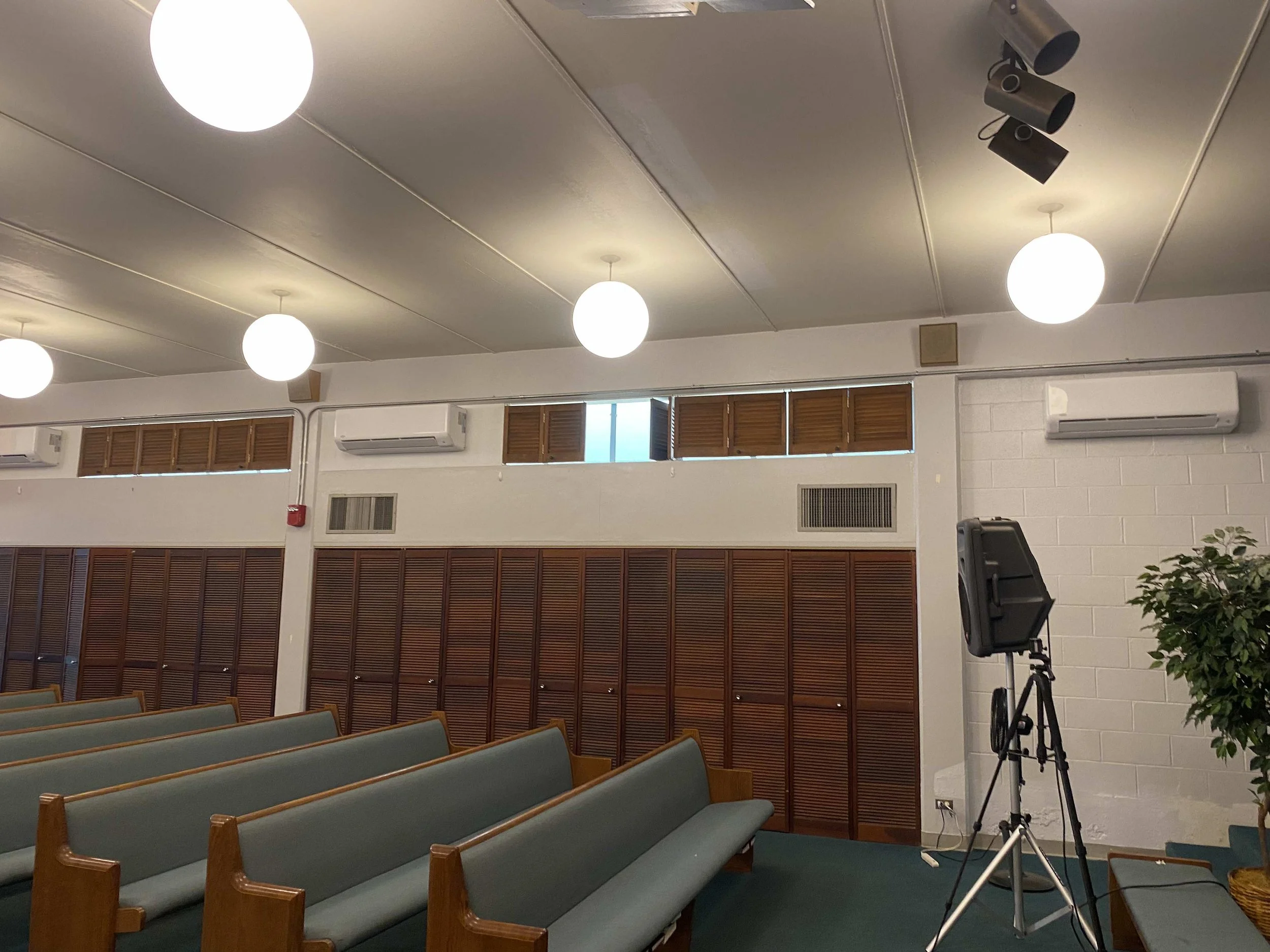 Three new mini-splits installed above church pews.