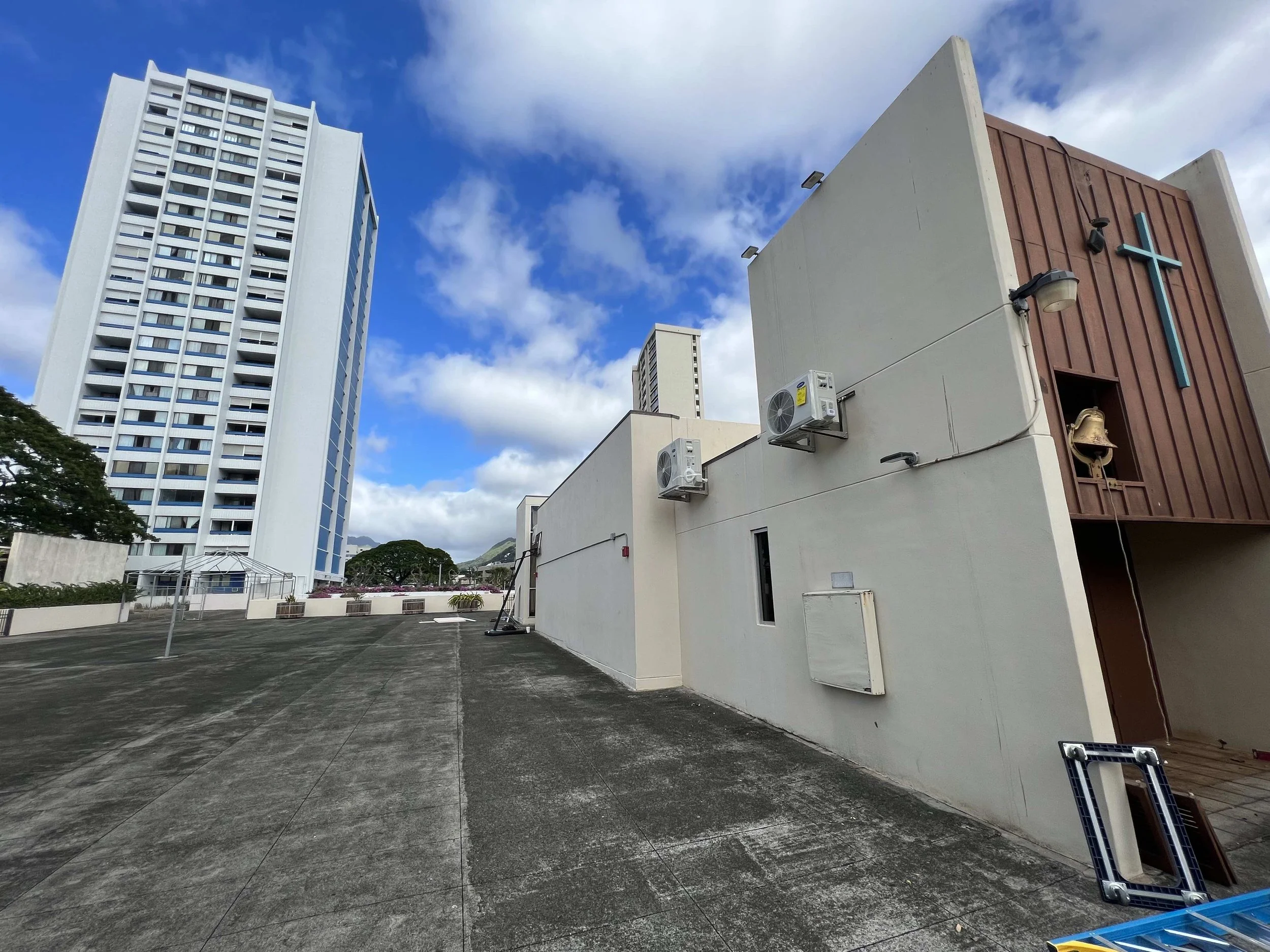 Zoomed out look at two of the four outdoor AC units on the rooftop 
