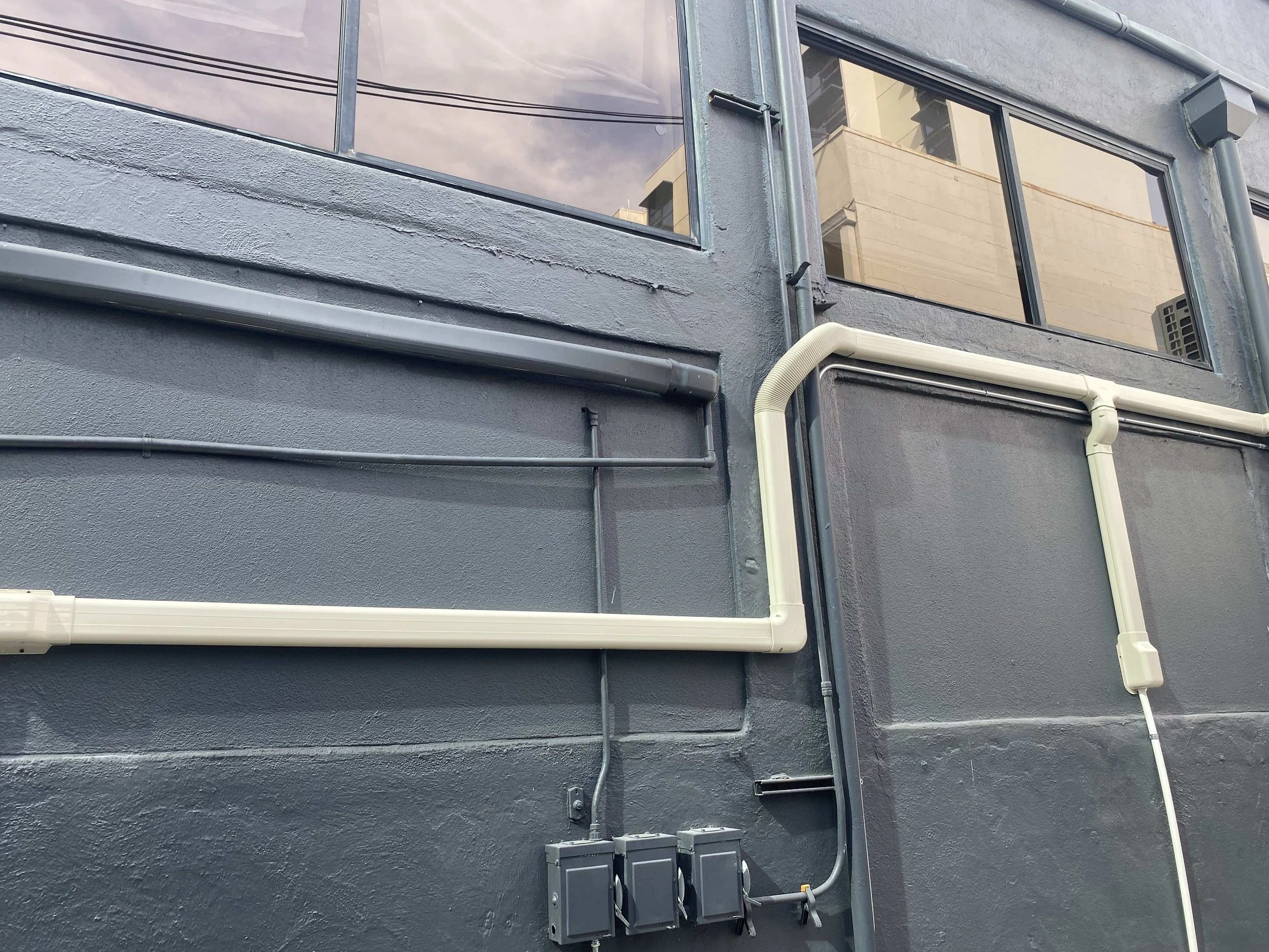 Close-up of AC piping on building's exterior