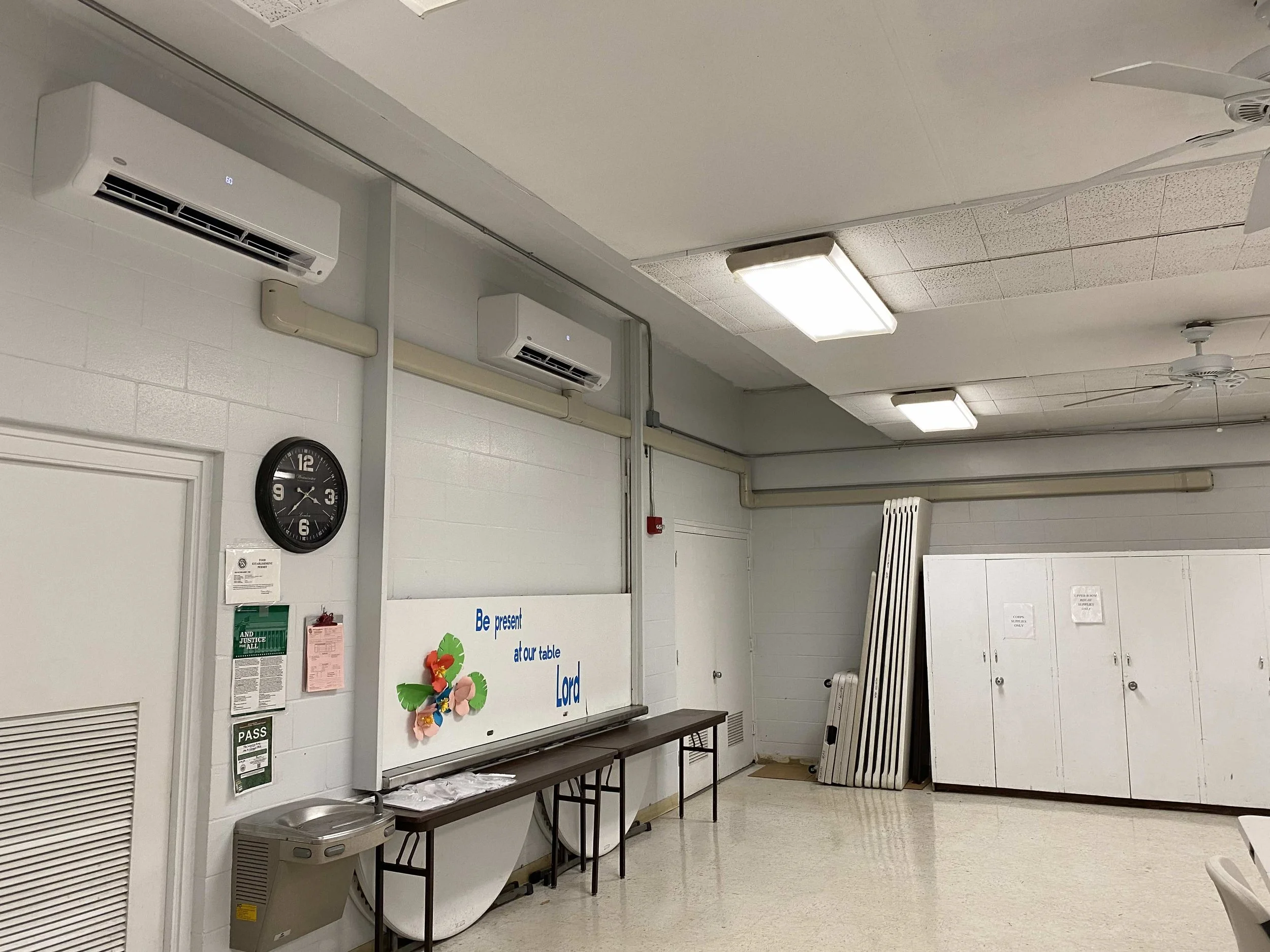 Two wall-mounted mini-split AC units seen from one angle in a room.