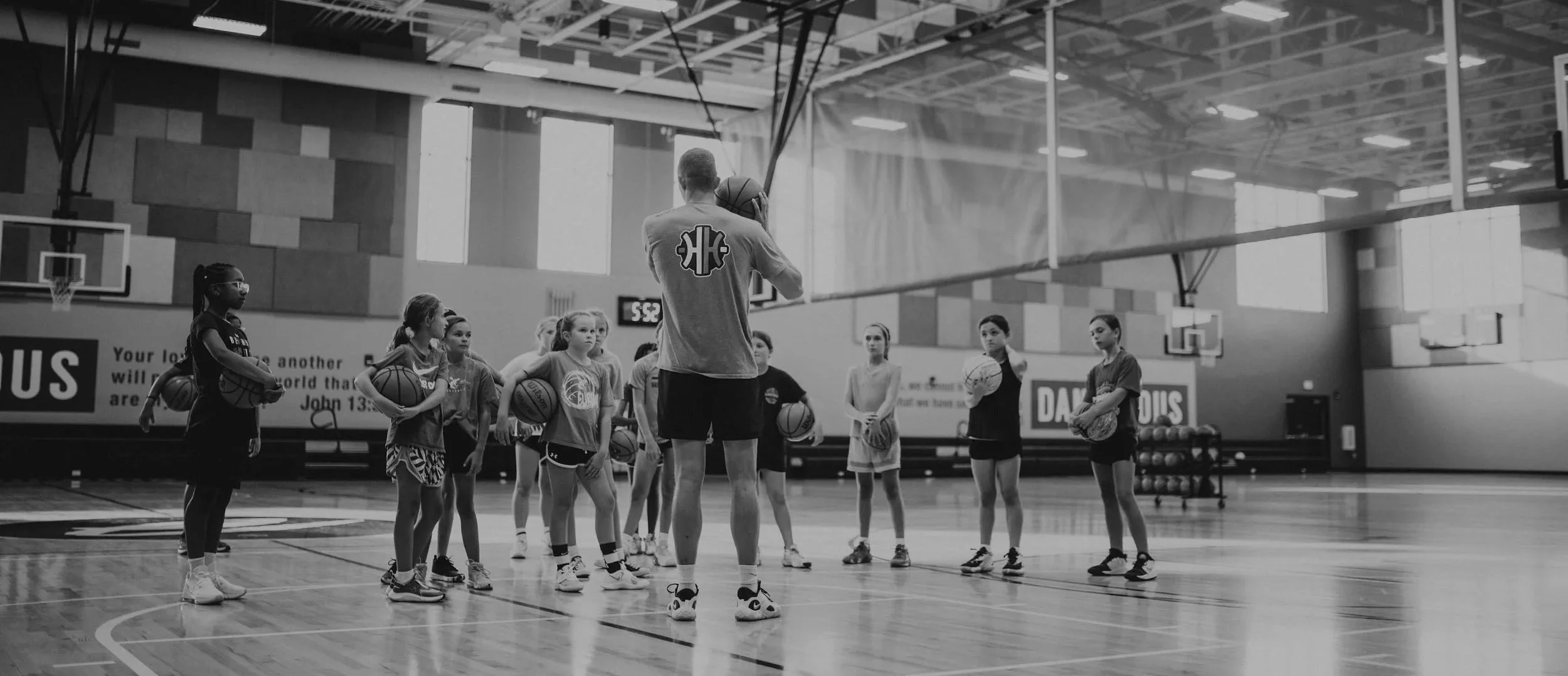 Coach demonstrating a drill to young basketball players