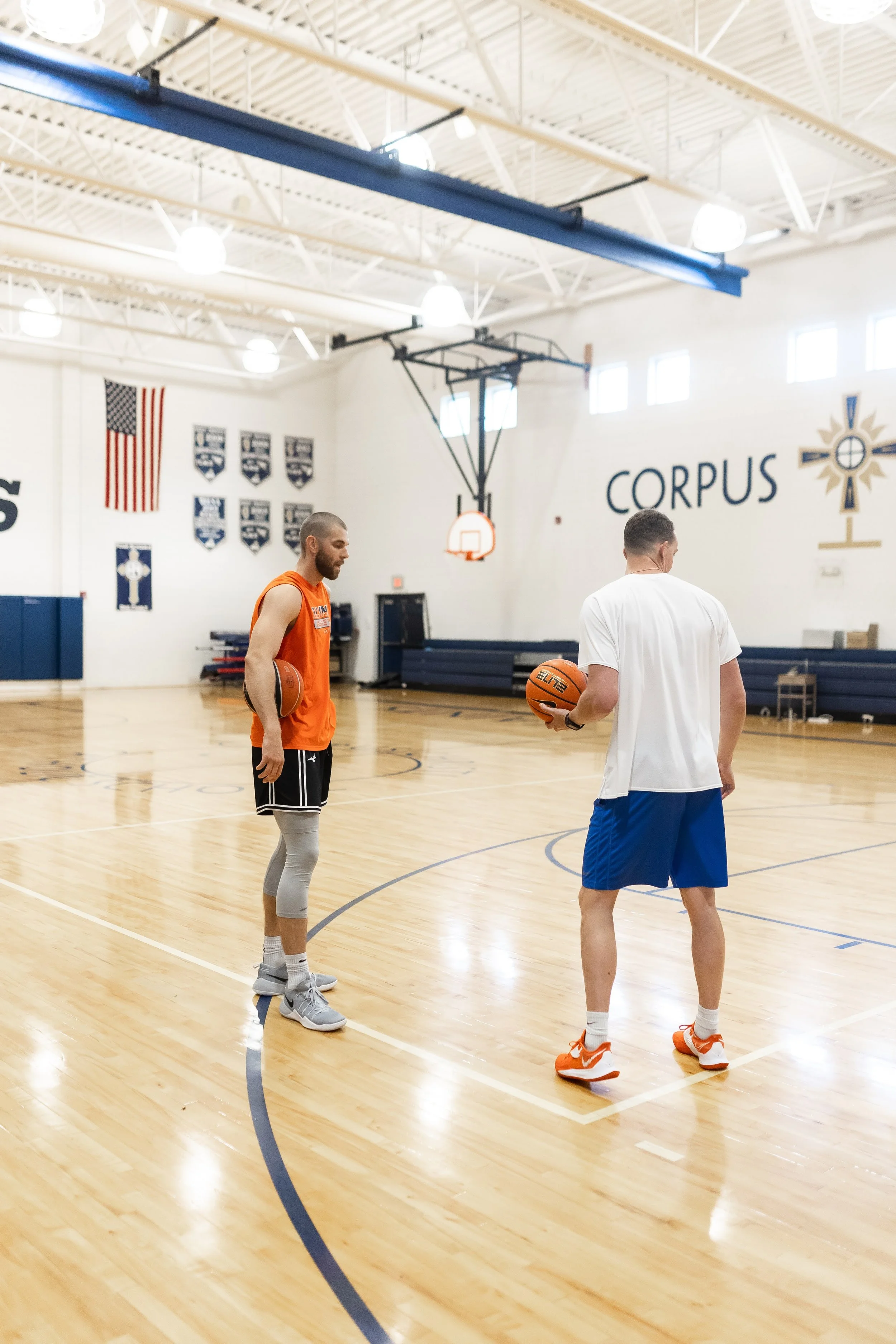 Coach and athlete discussing a basketball workout