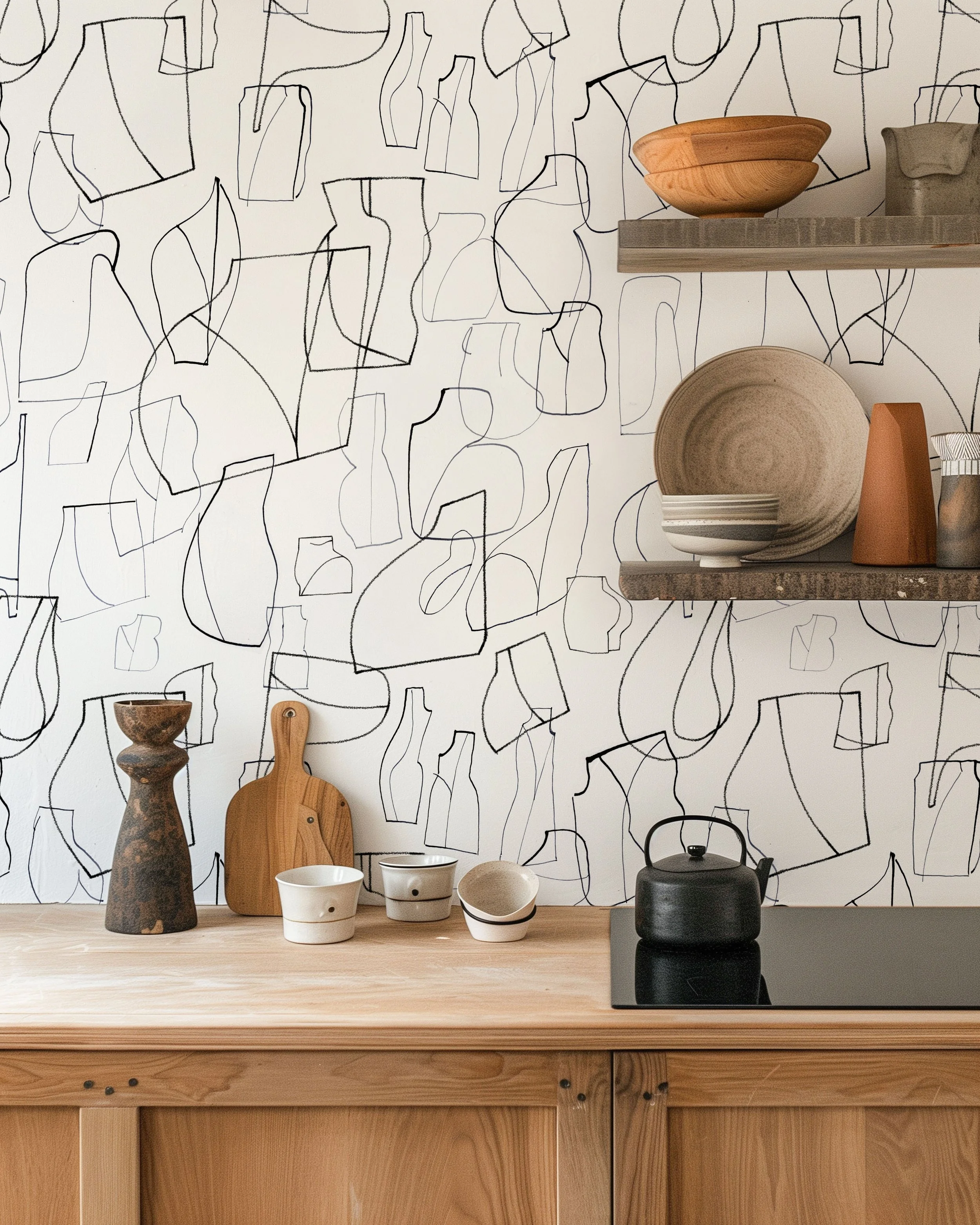 Decorative kitchen with wooden cabinets, abstract line art wallpaper, and shelves holding bowls and vases.