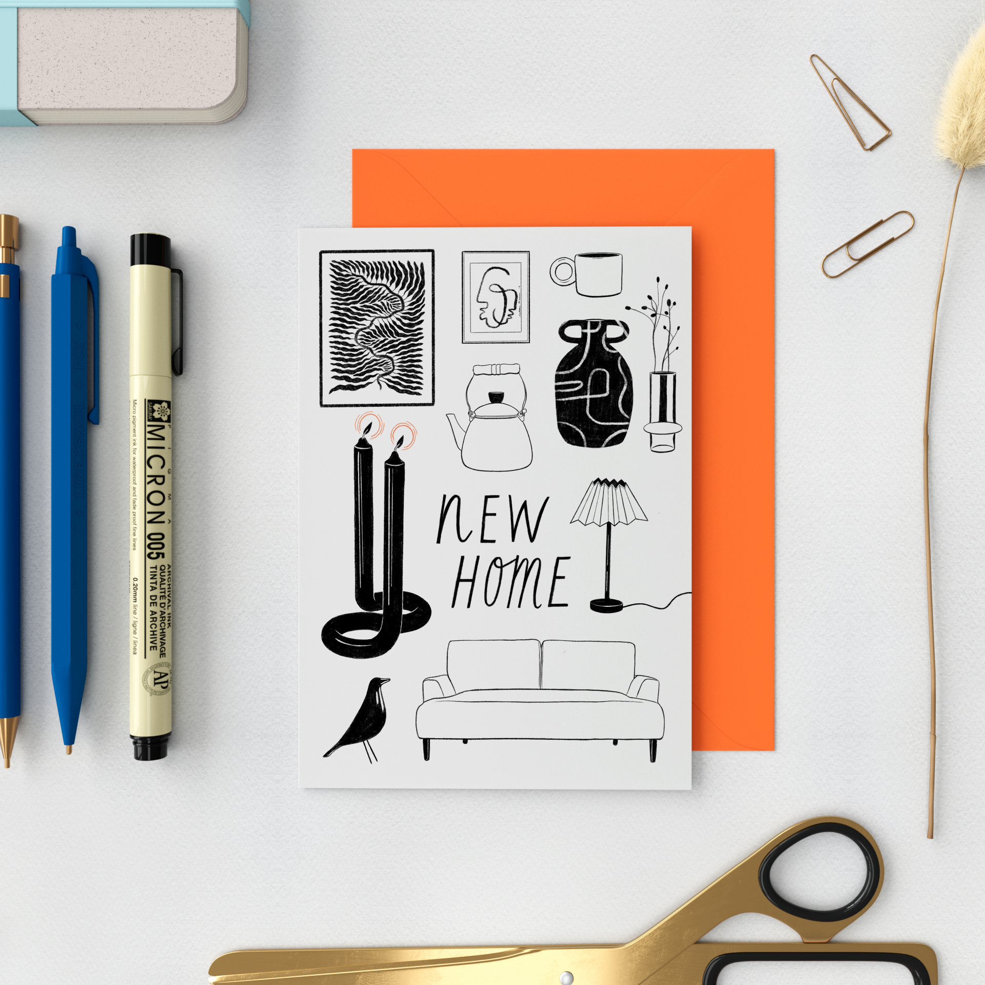 A black-and-white sketch of home decor and furniture items with the words 'NEW HOME' in the center, surrounded by objects like a sofa, candles, a lamp, a bird, a vase, and framed artwork.