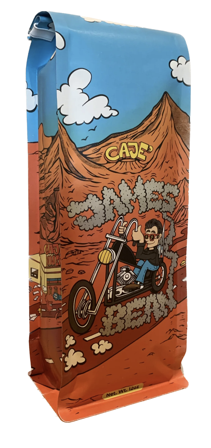 coffee pack for Cajè Coffee Santa Barbara picturing a white buy with a pair of shades driving an Harley Davidson chopper through the red desert
