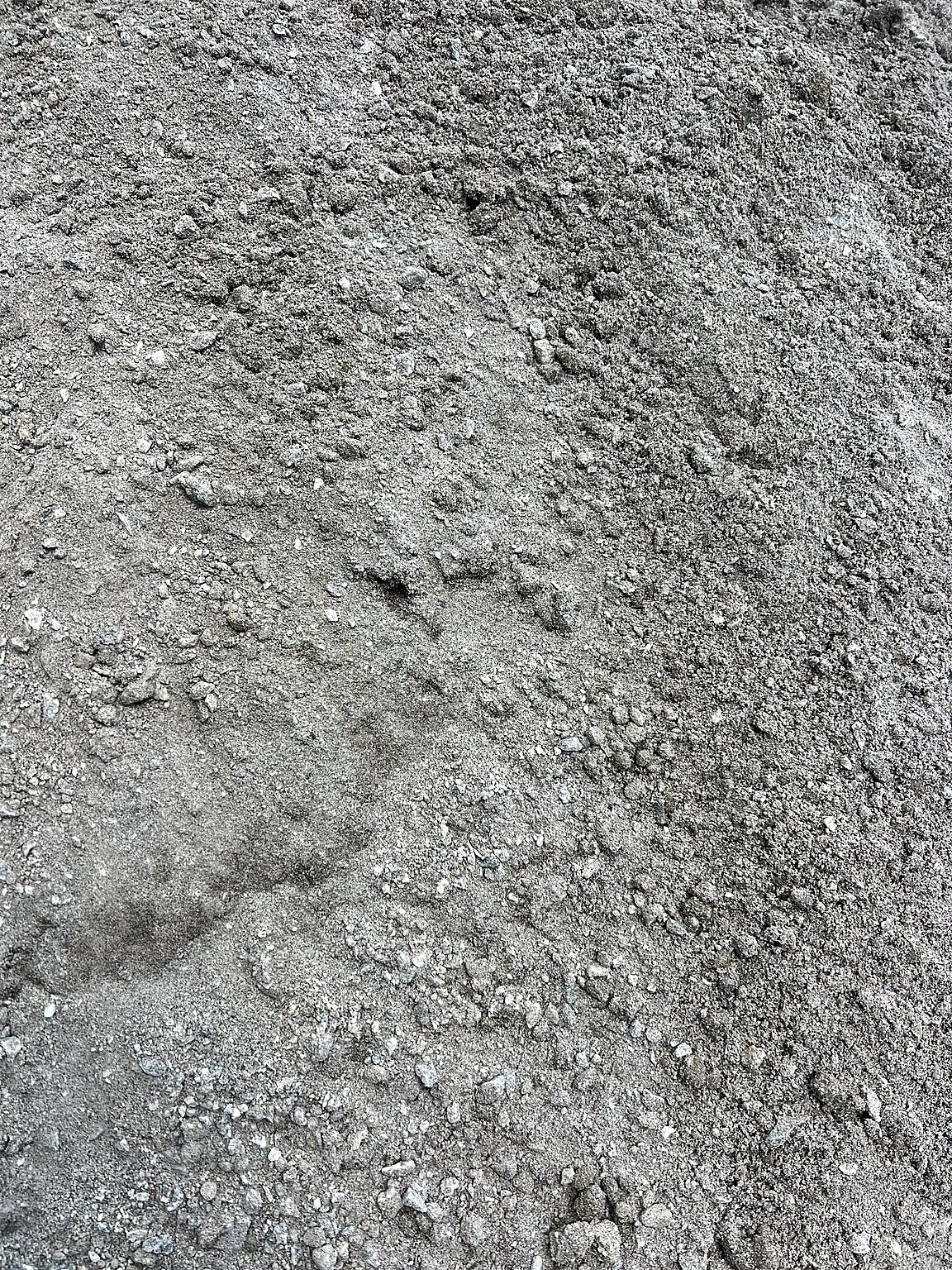 Stockpile of granite screenings showing the fine compactable crushed granite.