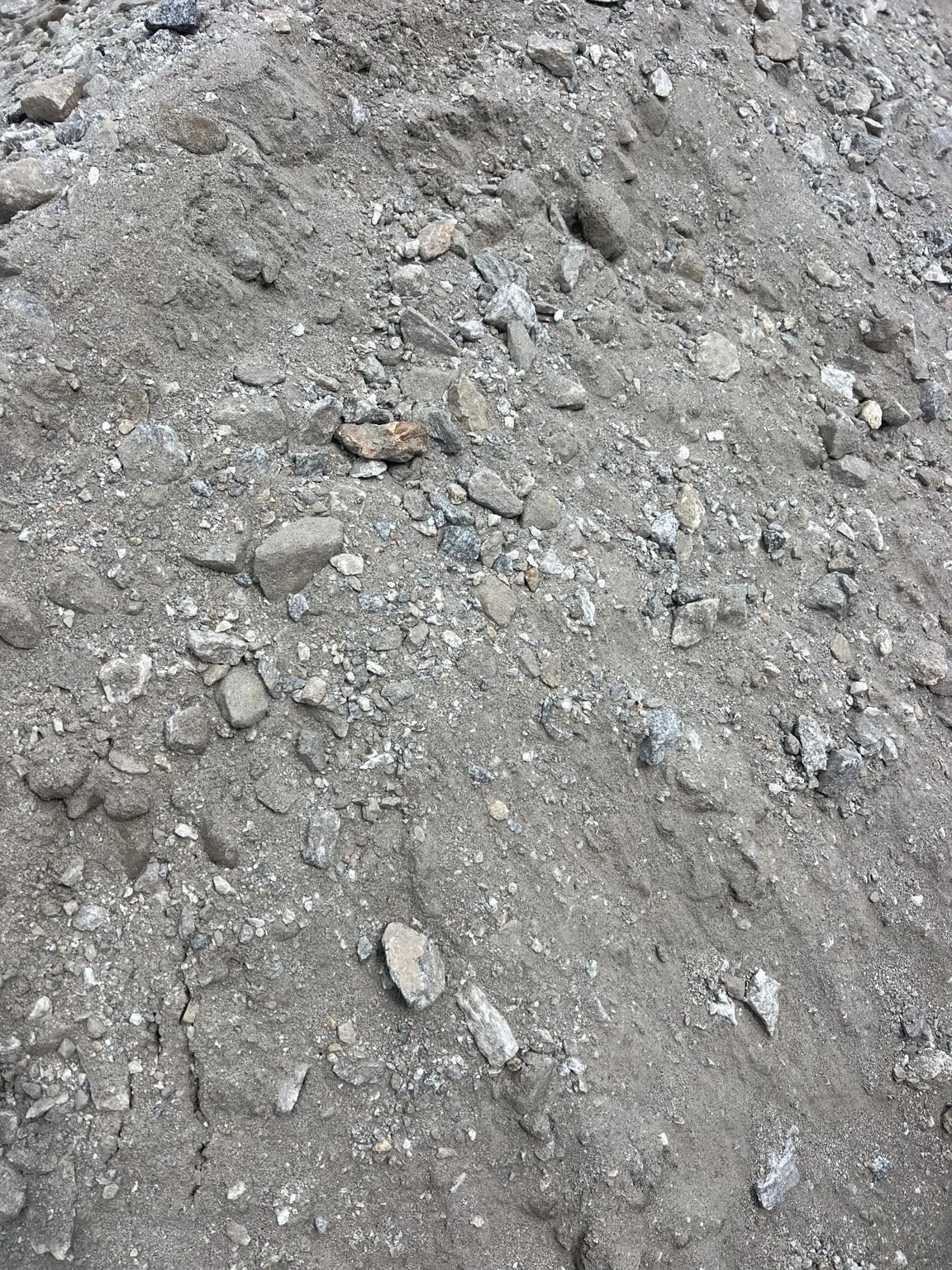 Crusher Run stockpile showing a compactable blend of crushed granite aggregate and stone fines.