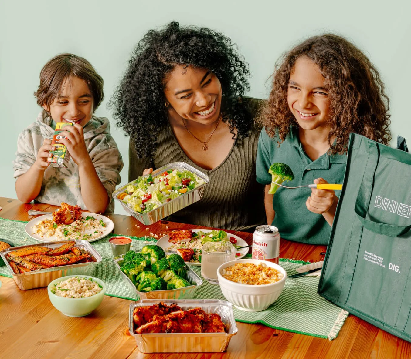 Family enjoying DIG healthy food with broccoli, rice, and chicken for a wholesome meal.