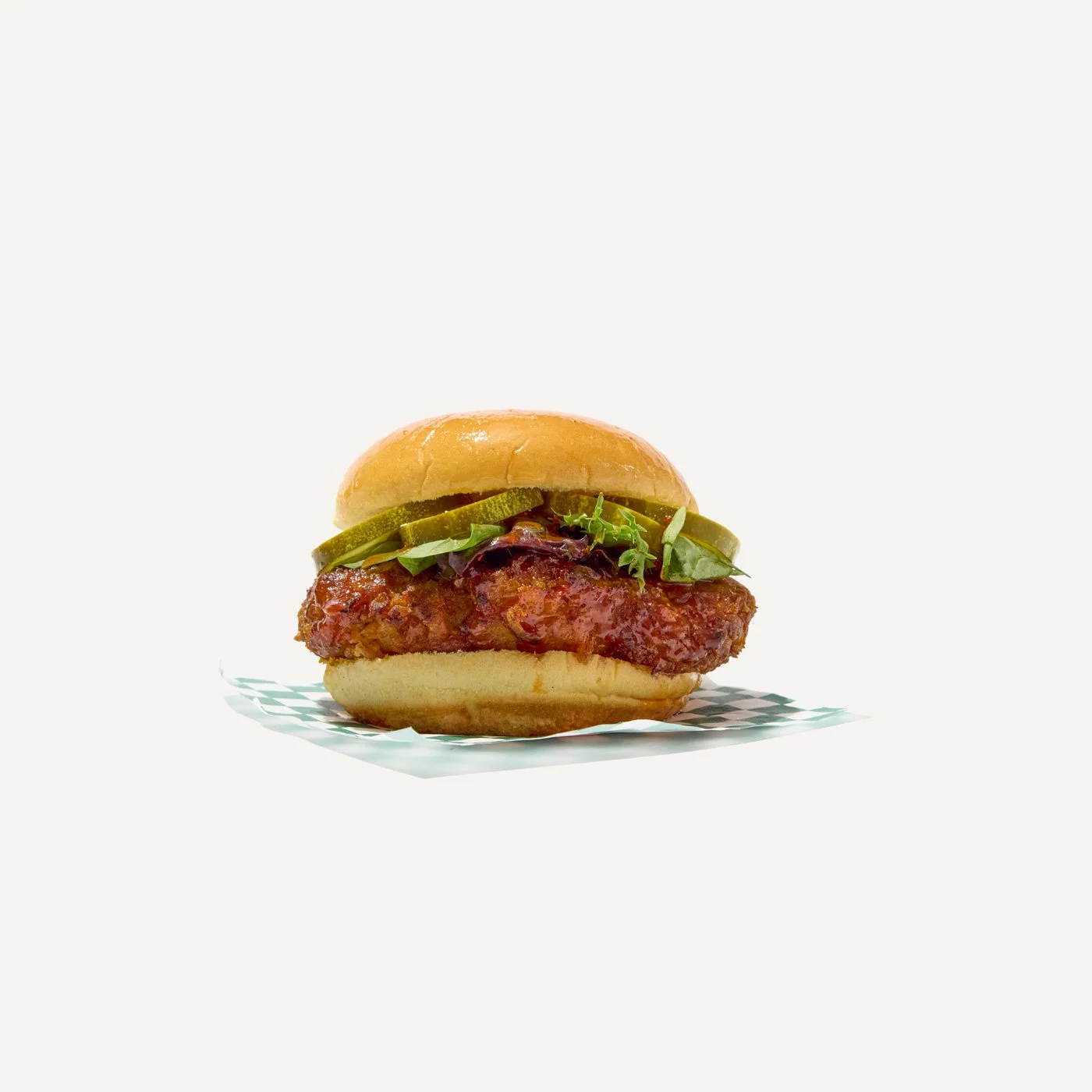 Hot honey crispy chicken sandwich with pickles and lettuce on a soft bun.
