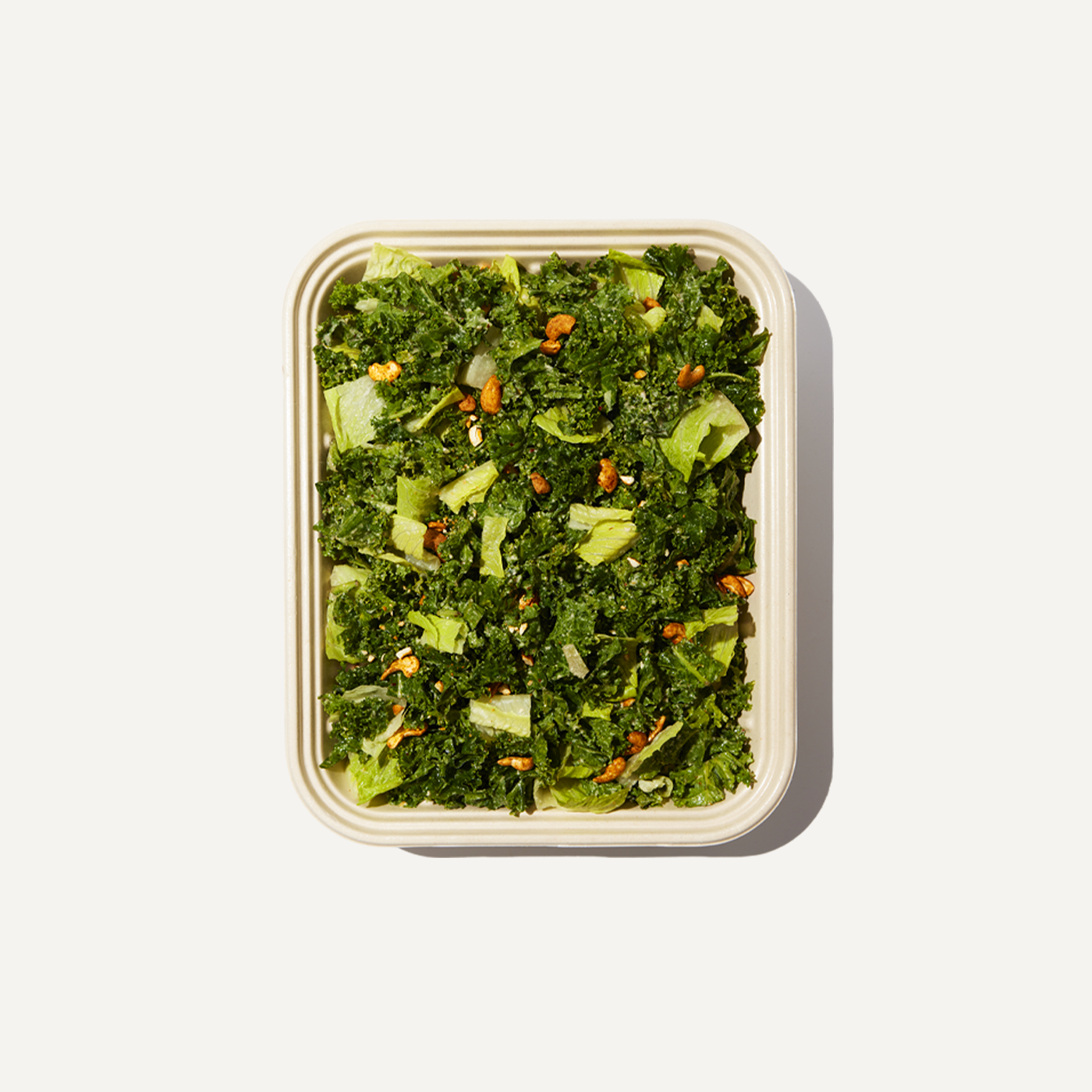 DIG Cashew Kale Caesar Tray with fresh kale, lettuce, and roasted cashews.