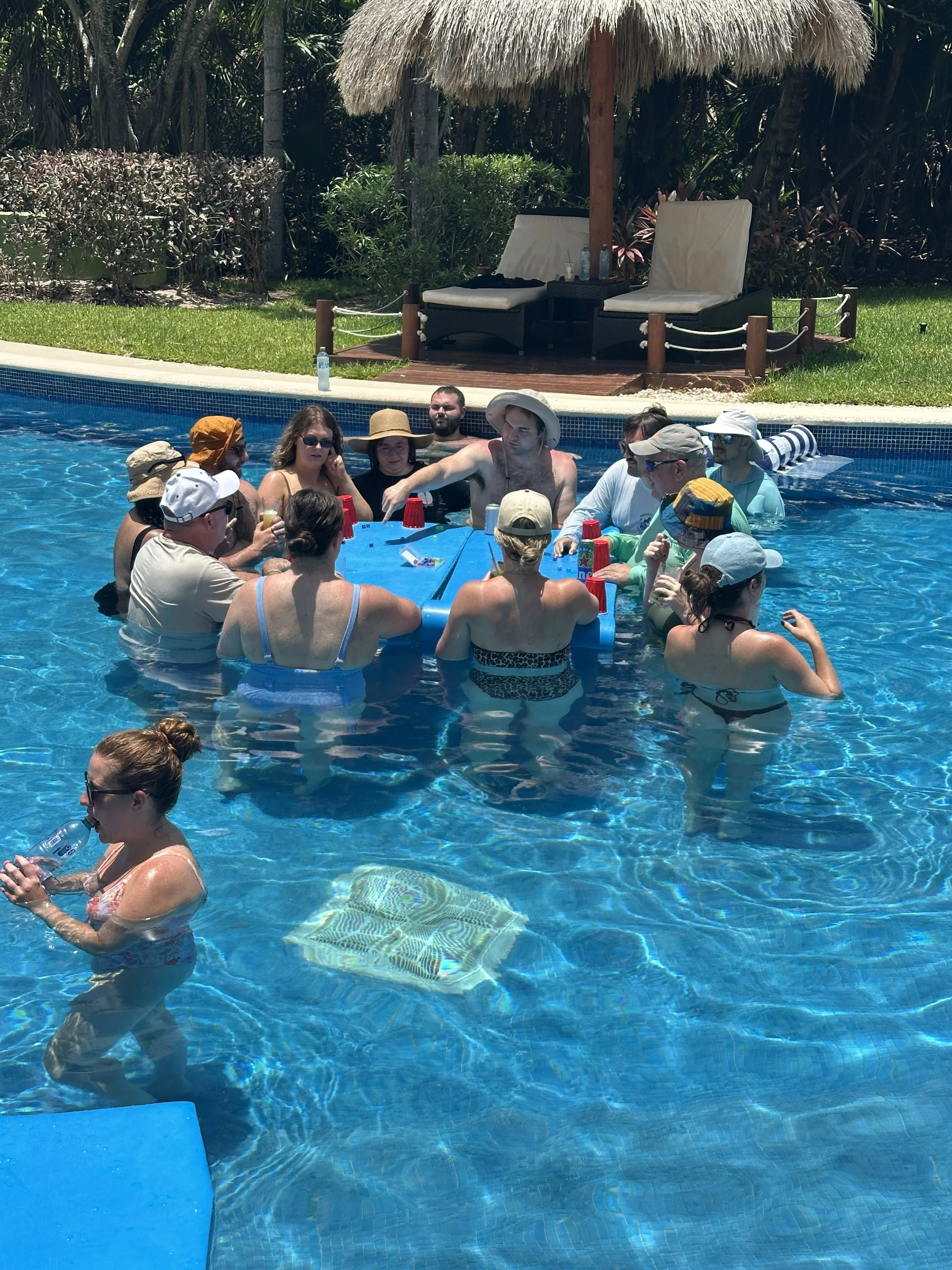 Wedding guests gathered in the Golden Pool at Valentin Imperial Riviera Maya