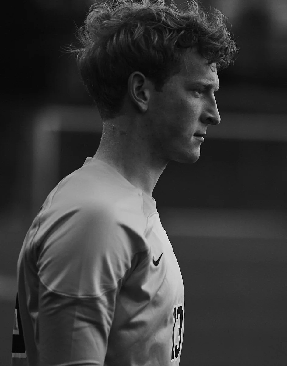 Profile of a young soccer player looking intently during a game