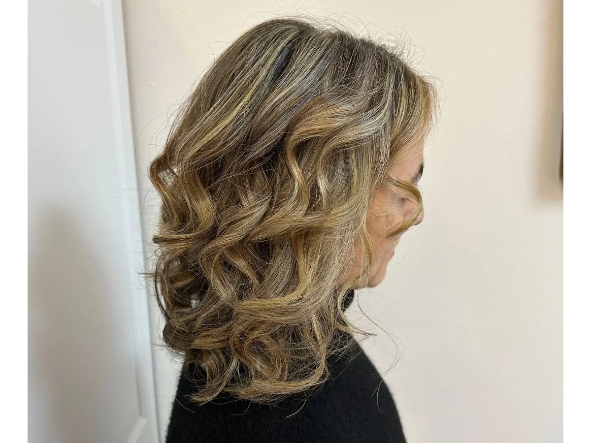 Woman with brunette hair featuring two-tone gray blending for added dimension and a softer grow-out.