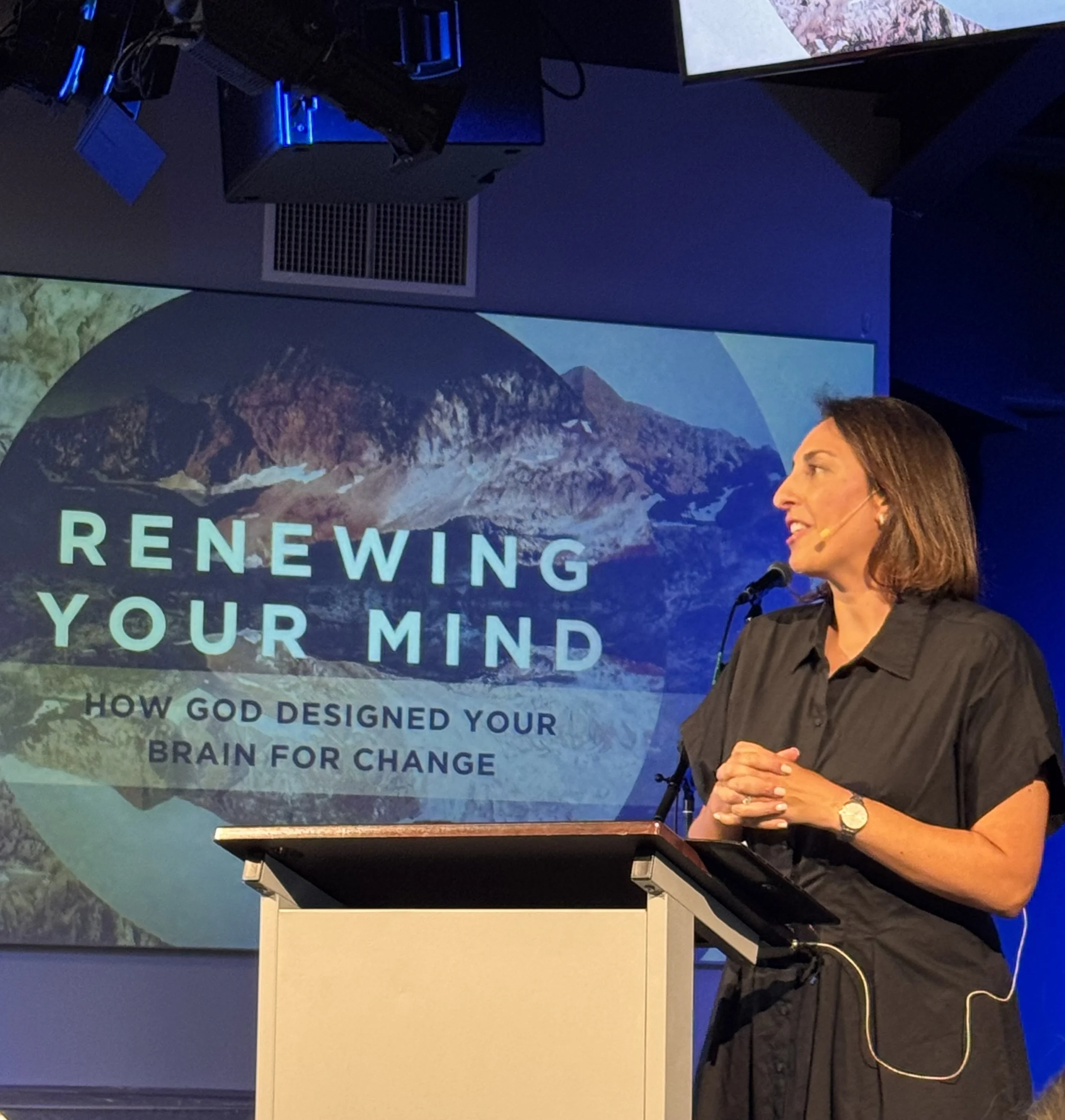 Woman on stage speaking about neuroscience