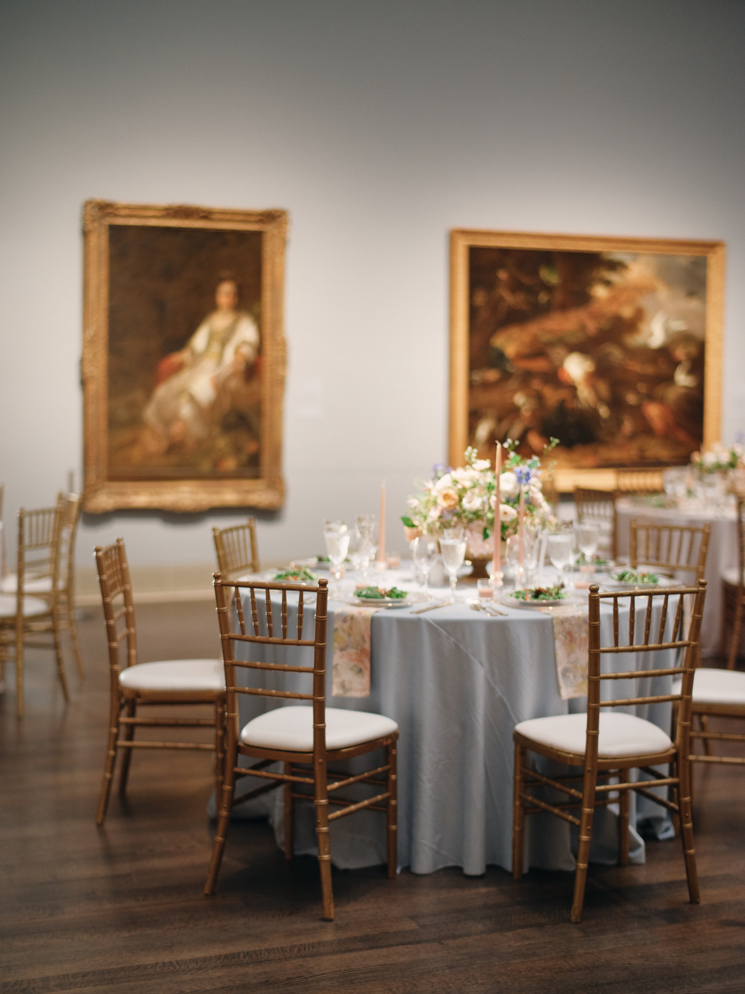 round table with flowers and place settings at a wedding reception at the Museum of Fine Arts, Houston